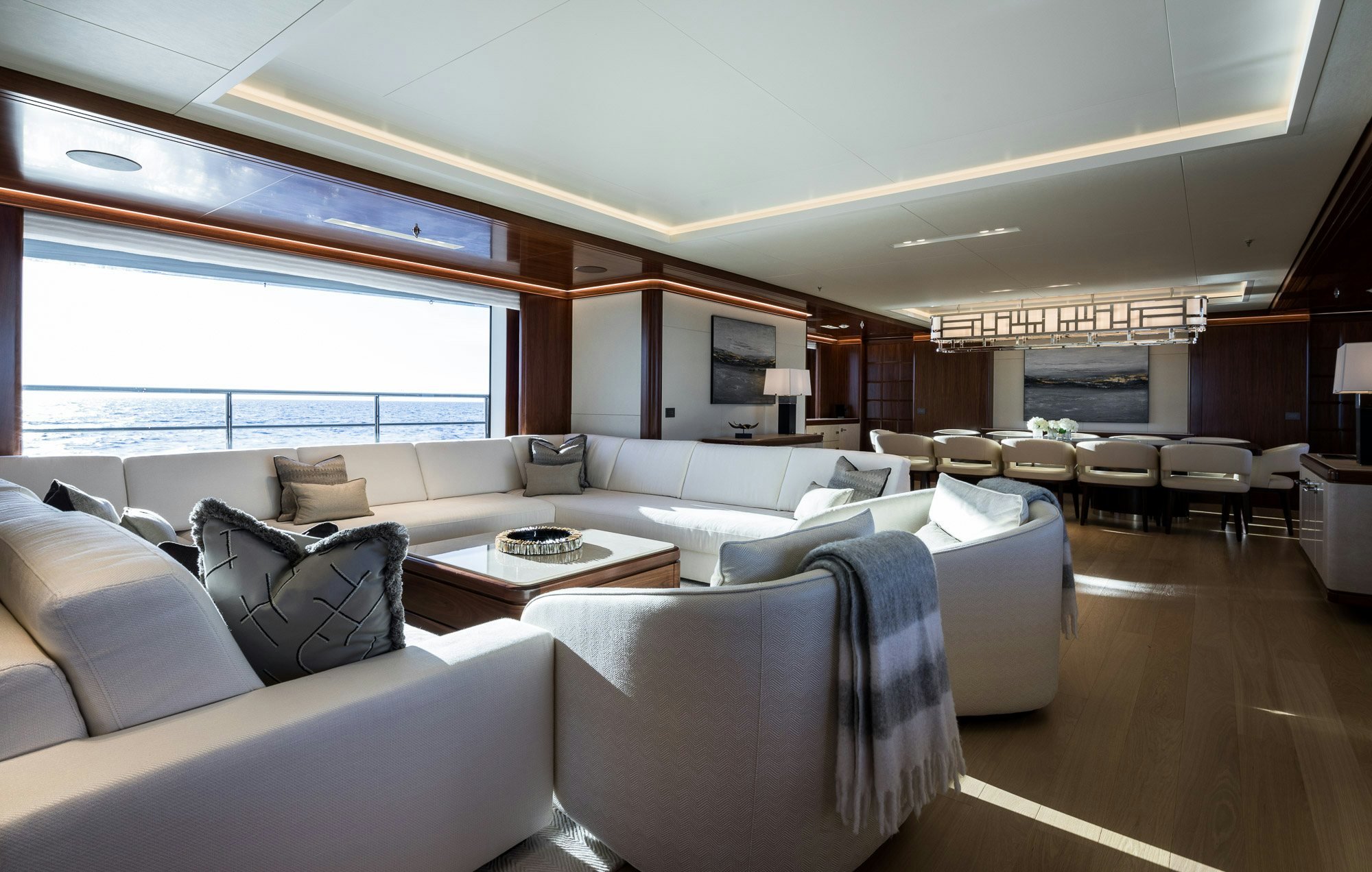 a living room with a large window aboard CALEX Yacht for Charter