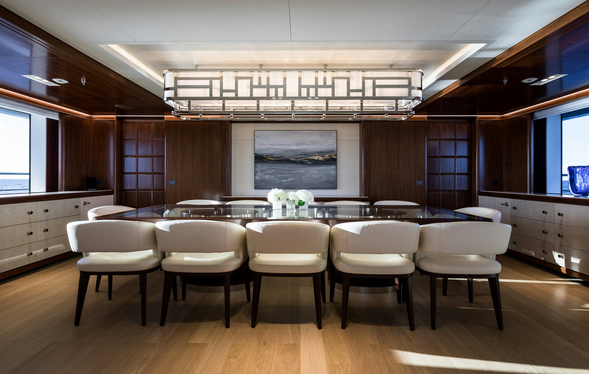 a large room with a table and chairs aboard CALEX Yacht for Charter