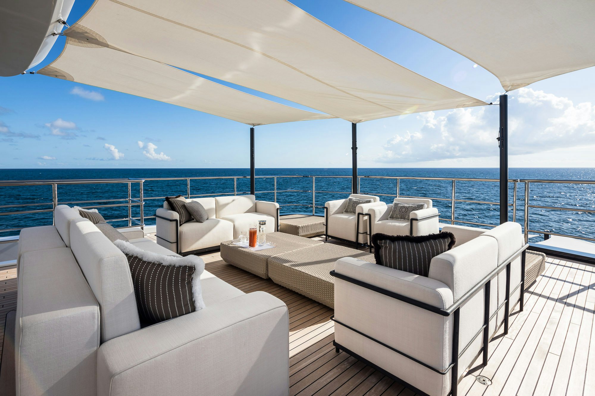 a large living room with a view of the ocean aboard CALEX Yacht for Charter