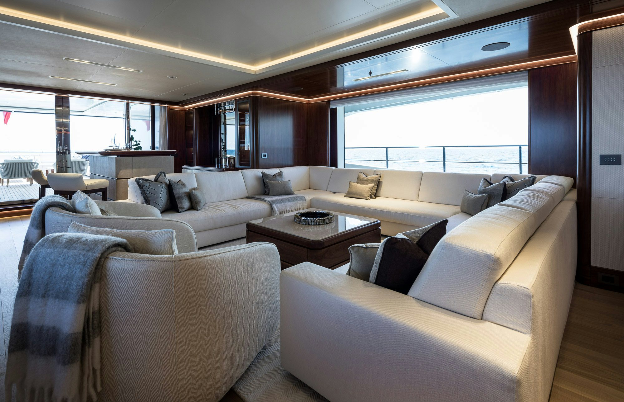 a living room with couches and a table aboard CALEX Yacht for Charter