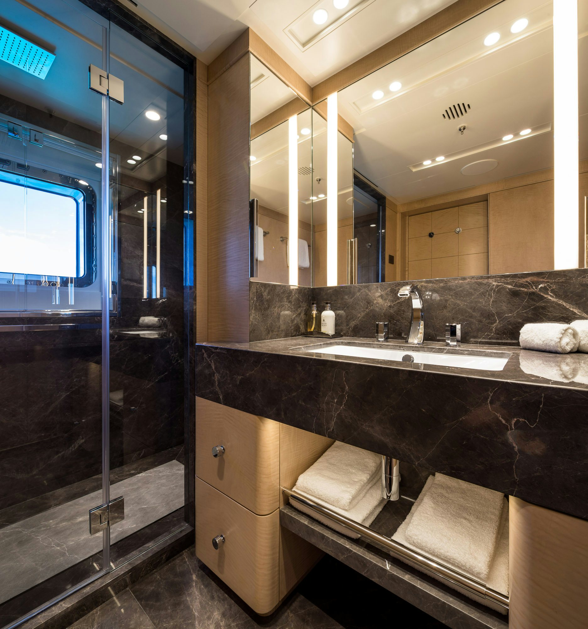 a bathroom with a large mirror aboard CALEX Yacht for Charter