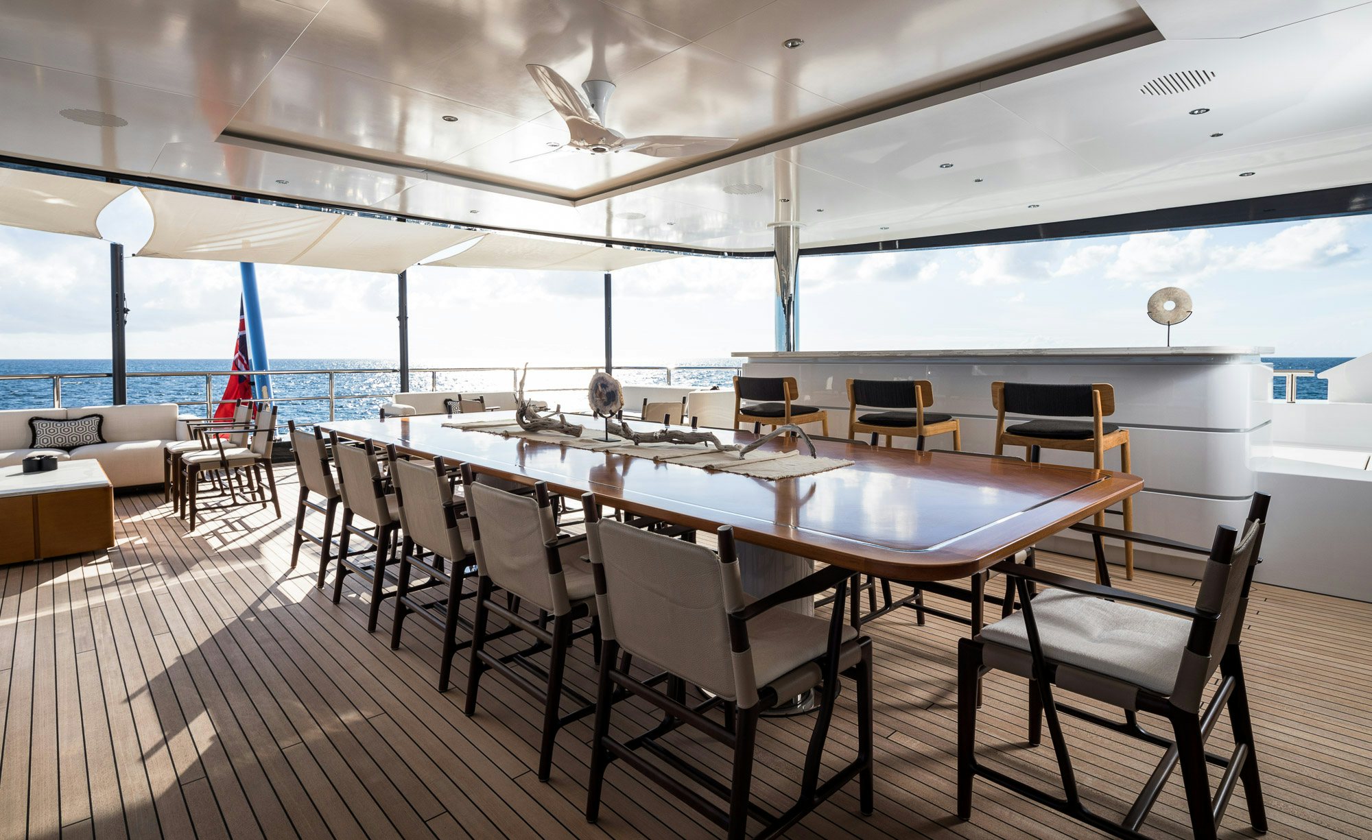 a large dining table with chairs around it aboard CALEX Yacht for Charter