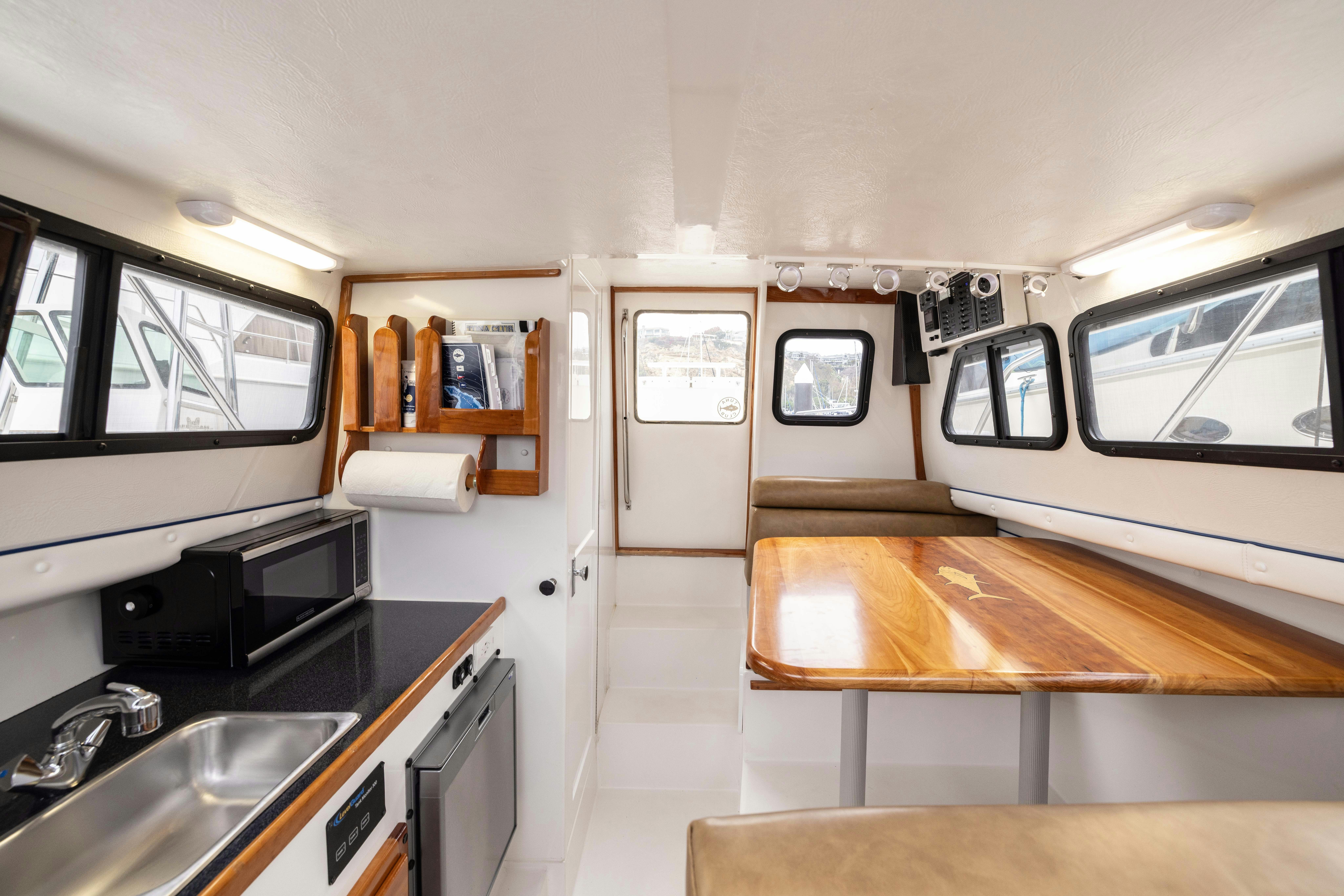 a kitchen with a table and a sink aboard 5TH KID Yacht for Sale