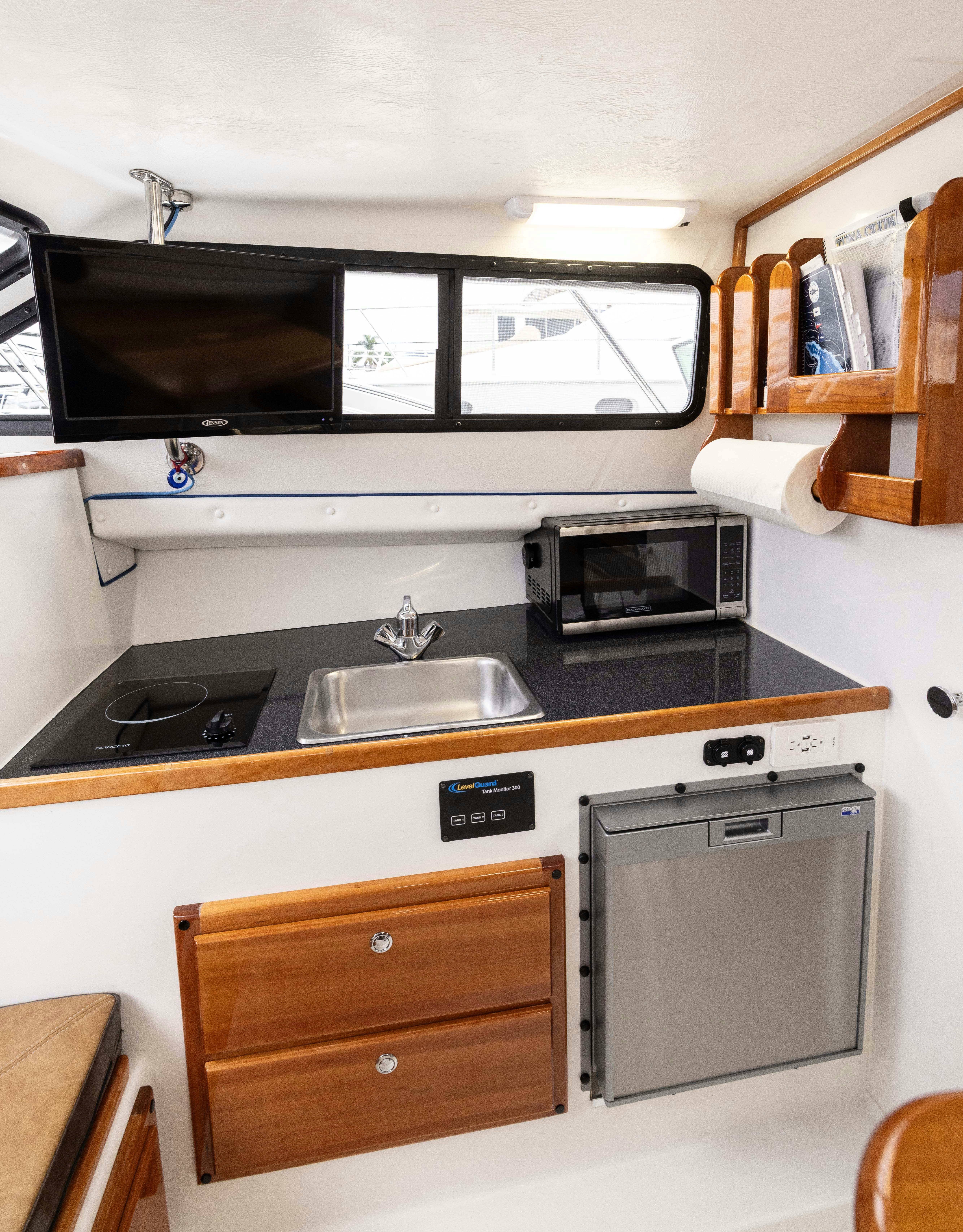 a kitchen with a microwave oven and a sink aboard 5TH KID Yacht for Sale