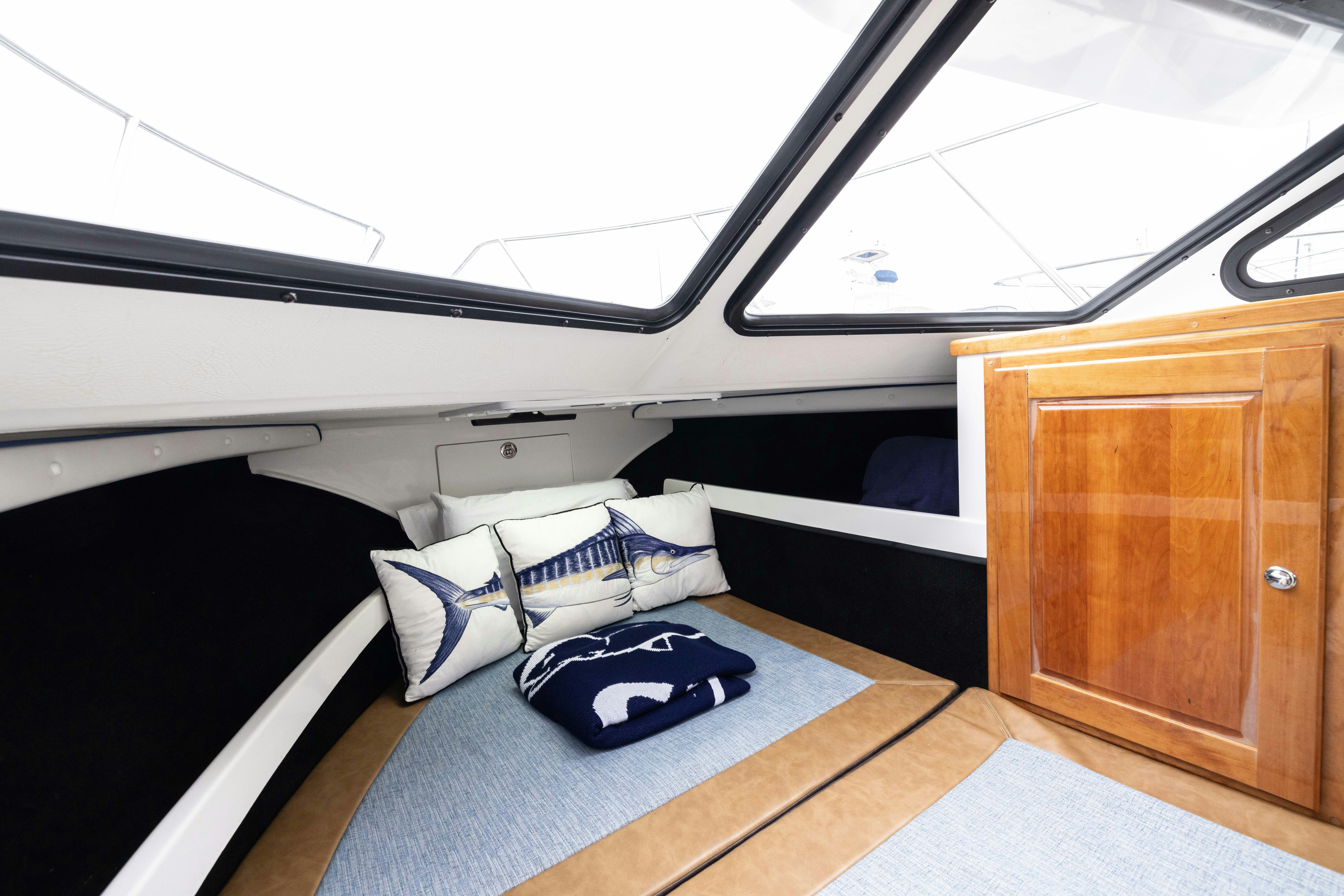 a room with a bed and a wood cabinet aboard 5TH KID Yacht for Sale