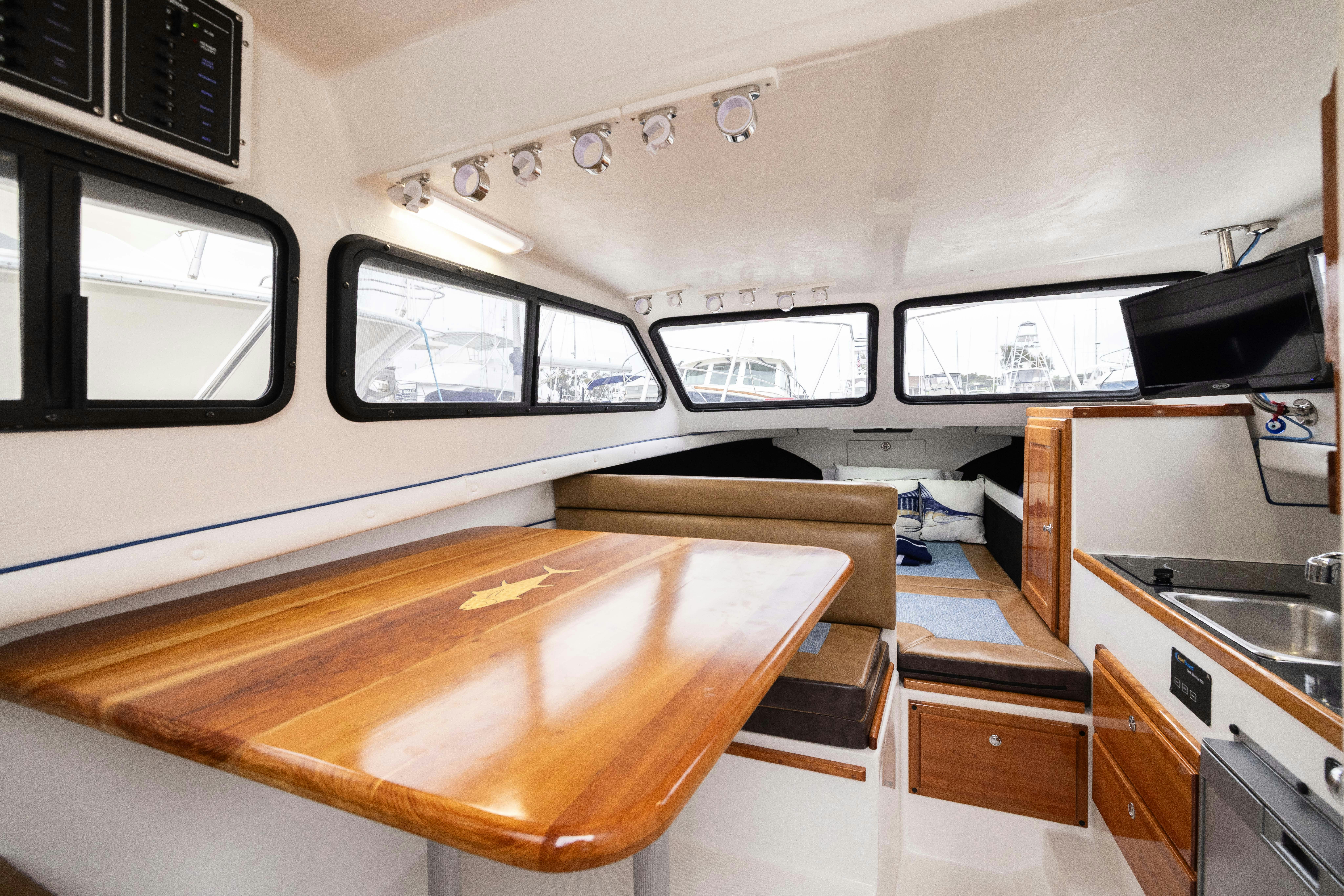 a kitchen with a table and cabinets aboard 5TH KID Yacht for Sale