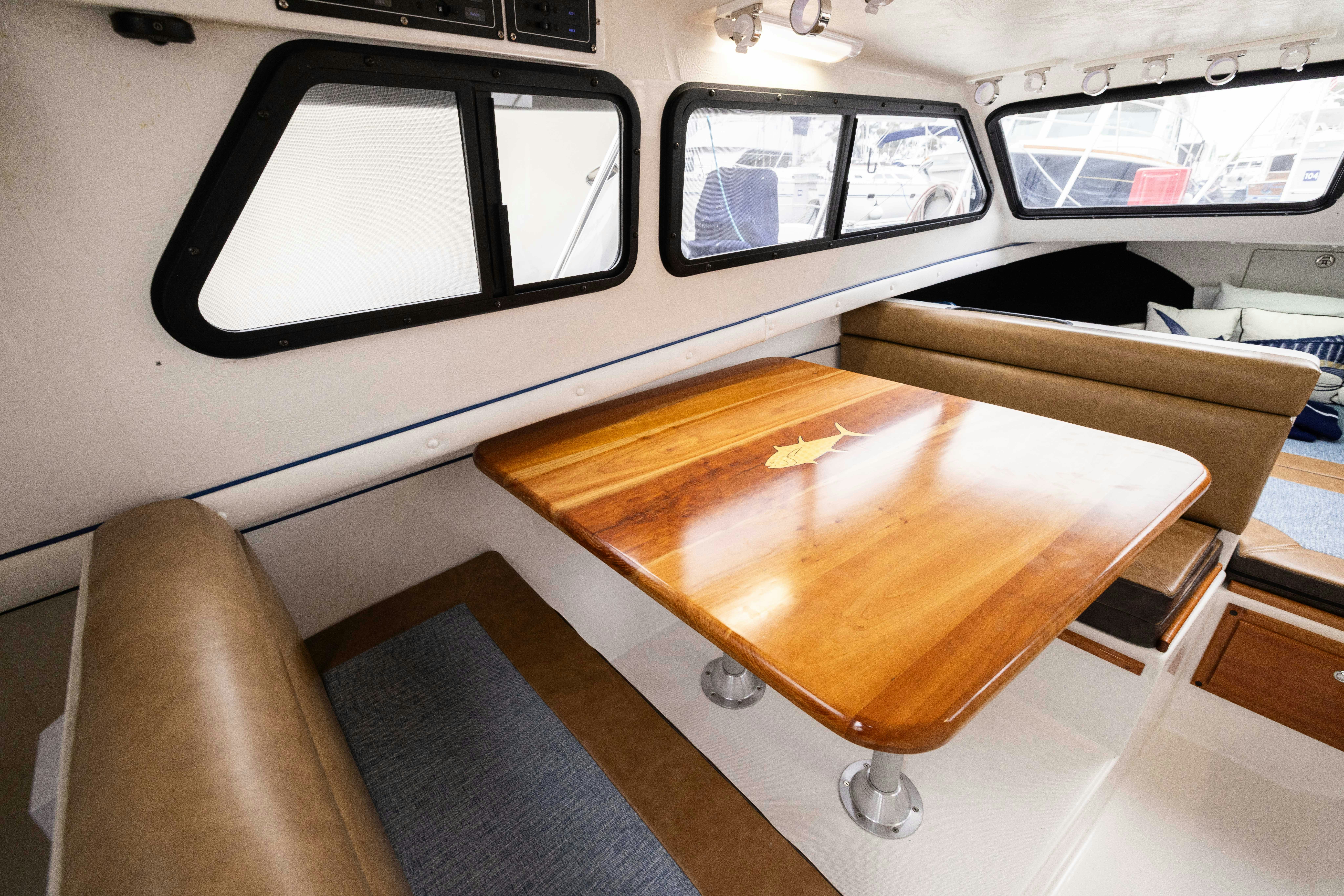 a wooden table in a car aboard 5TH KID Yacht for Sale