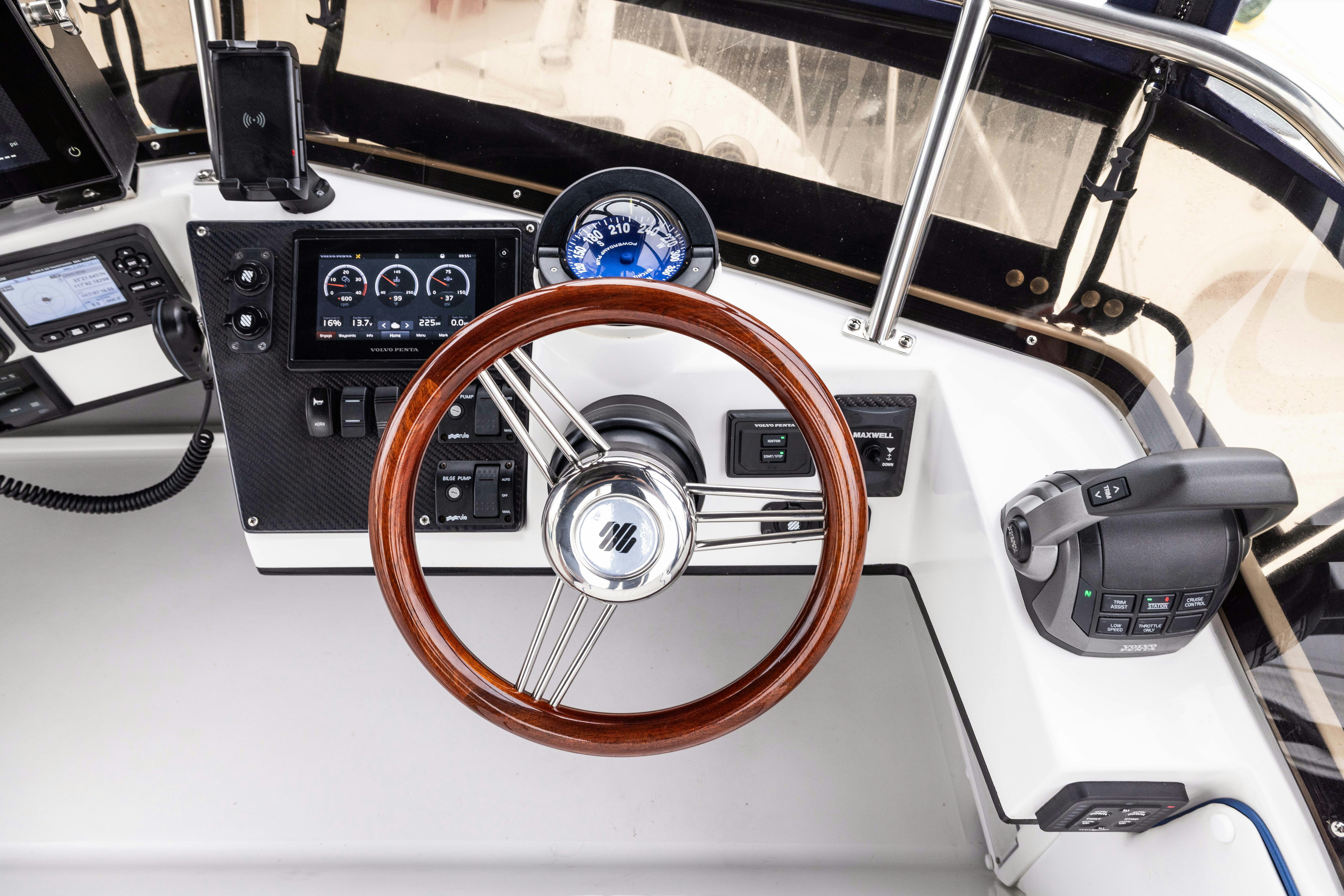 a steering wheel and dashboard of a car aboard 5TH KID Yacht for Sale