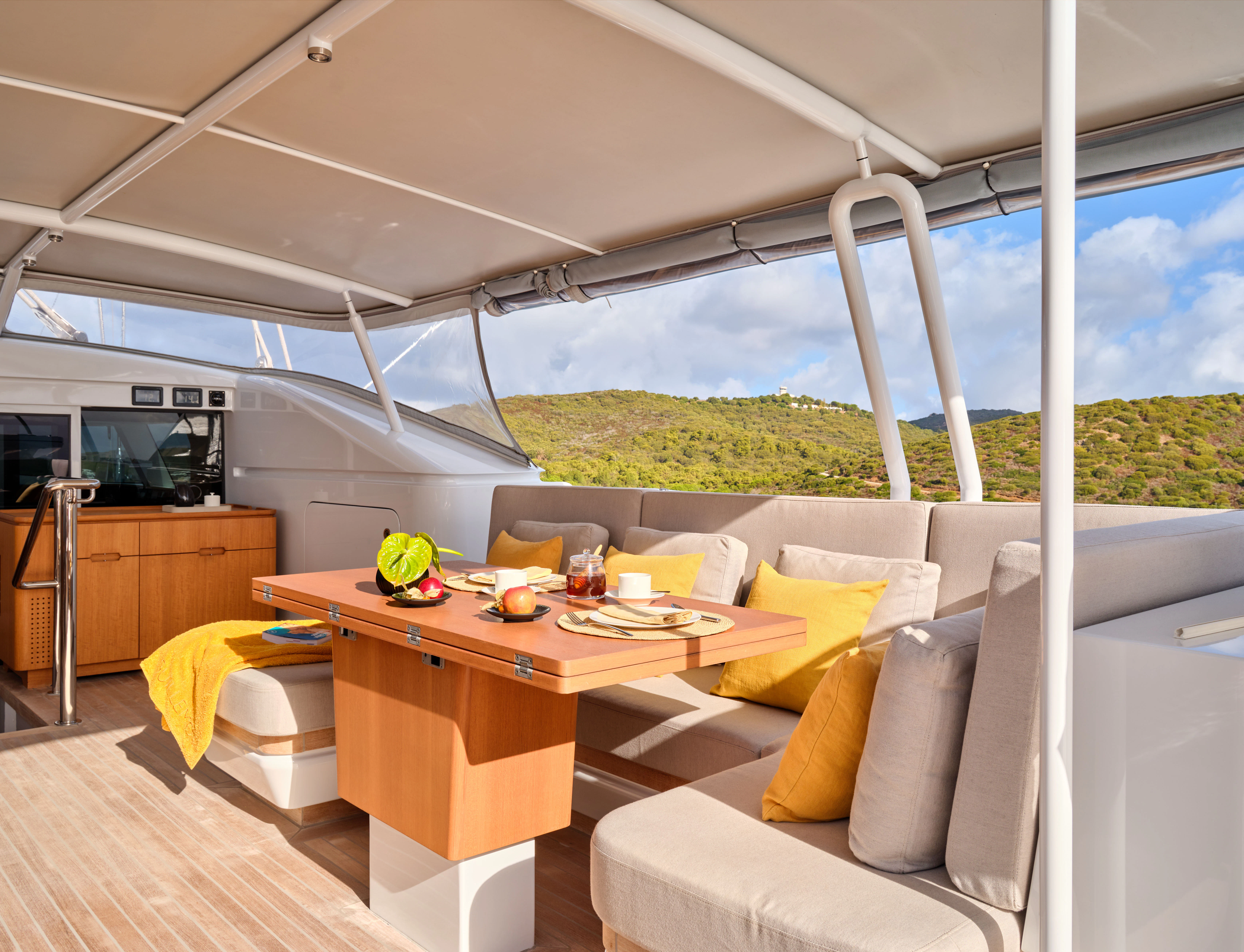 a table with chairs and a couch aboard GUILLEMOT Yacht for Charter