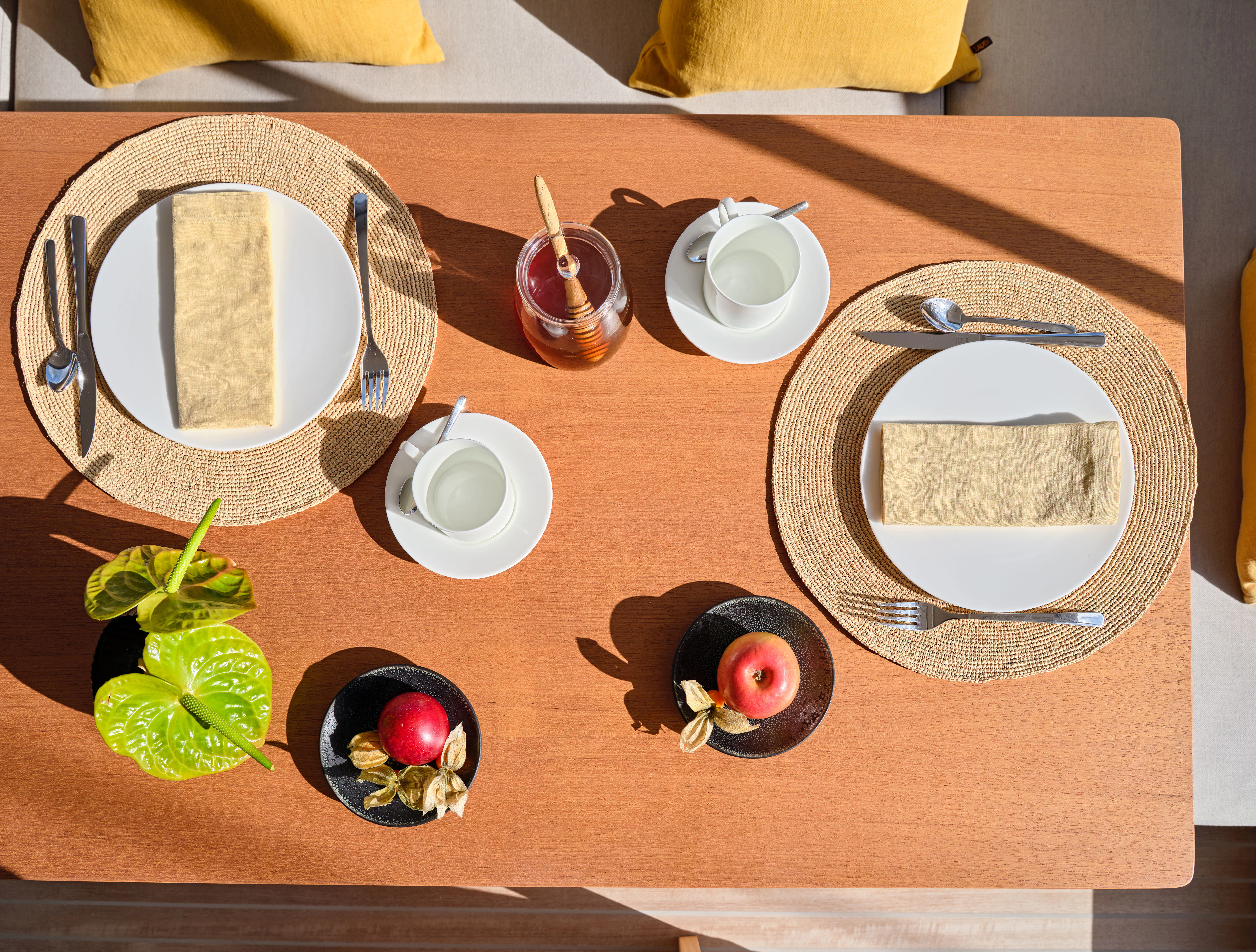 a table with dishes and plates aboard GUILLEMOT Yacht for Charter