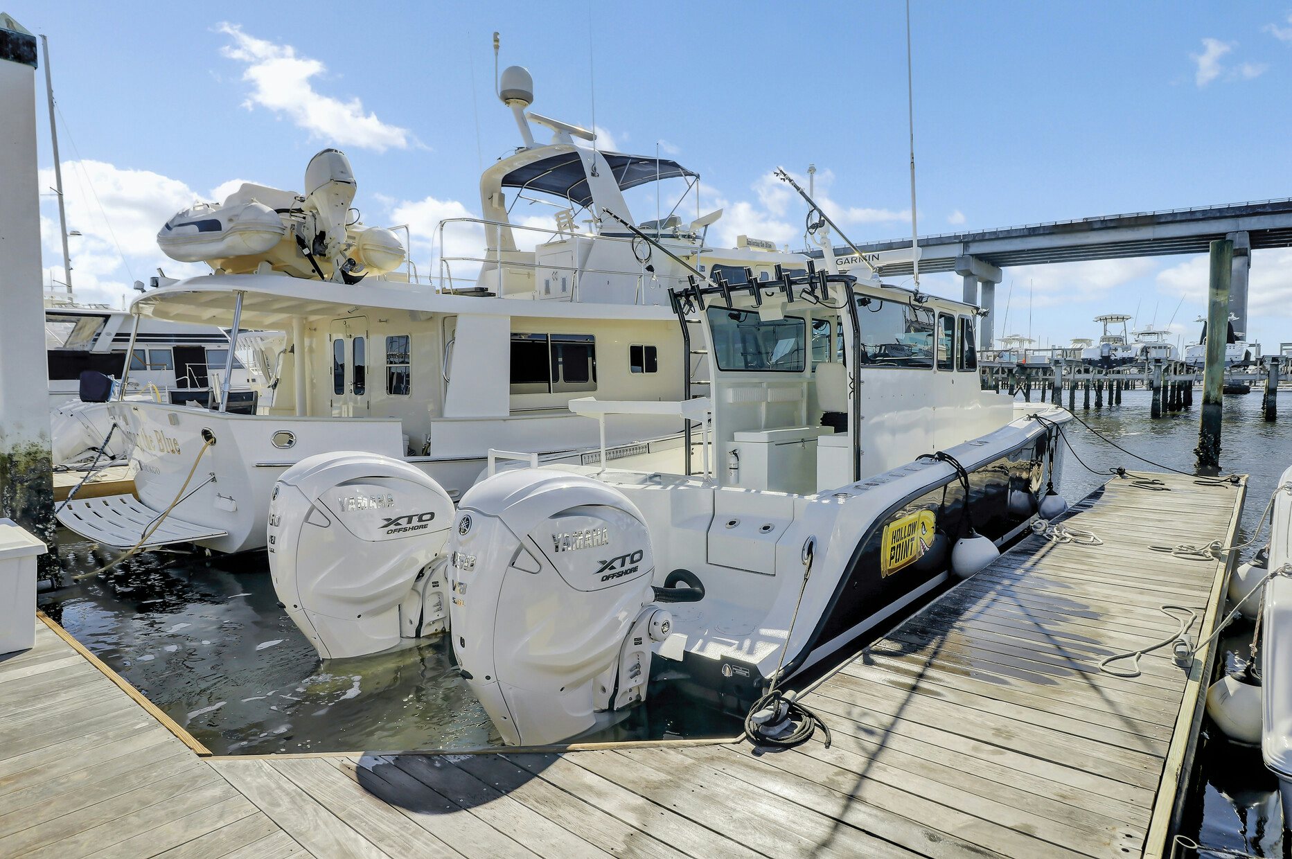 a large white boat on a dock aboard OUR TRADE Yacht for Sale