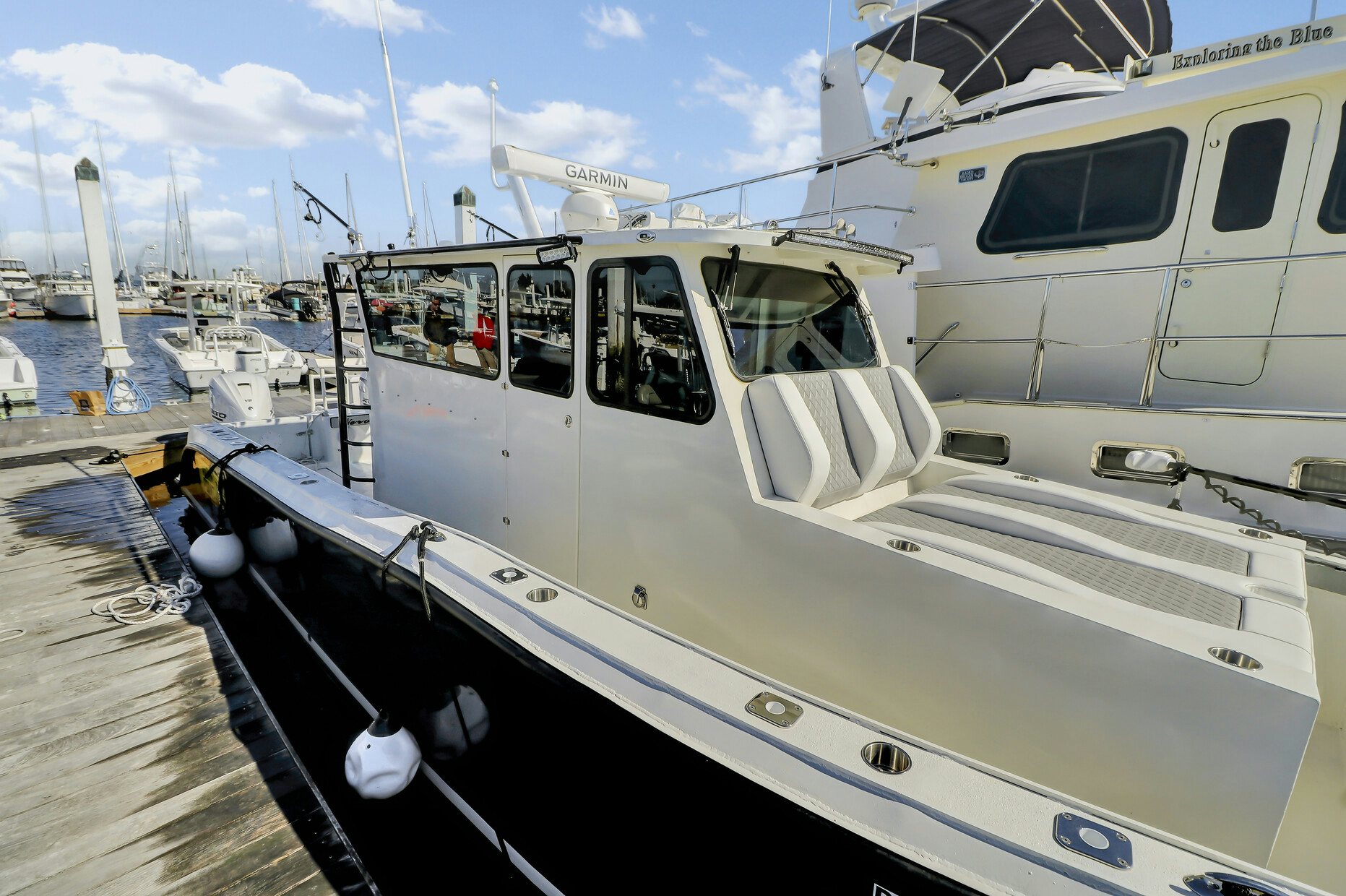 a white boat docked aboard OUR TRADE Yacht for Sale