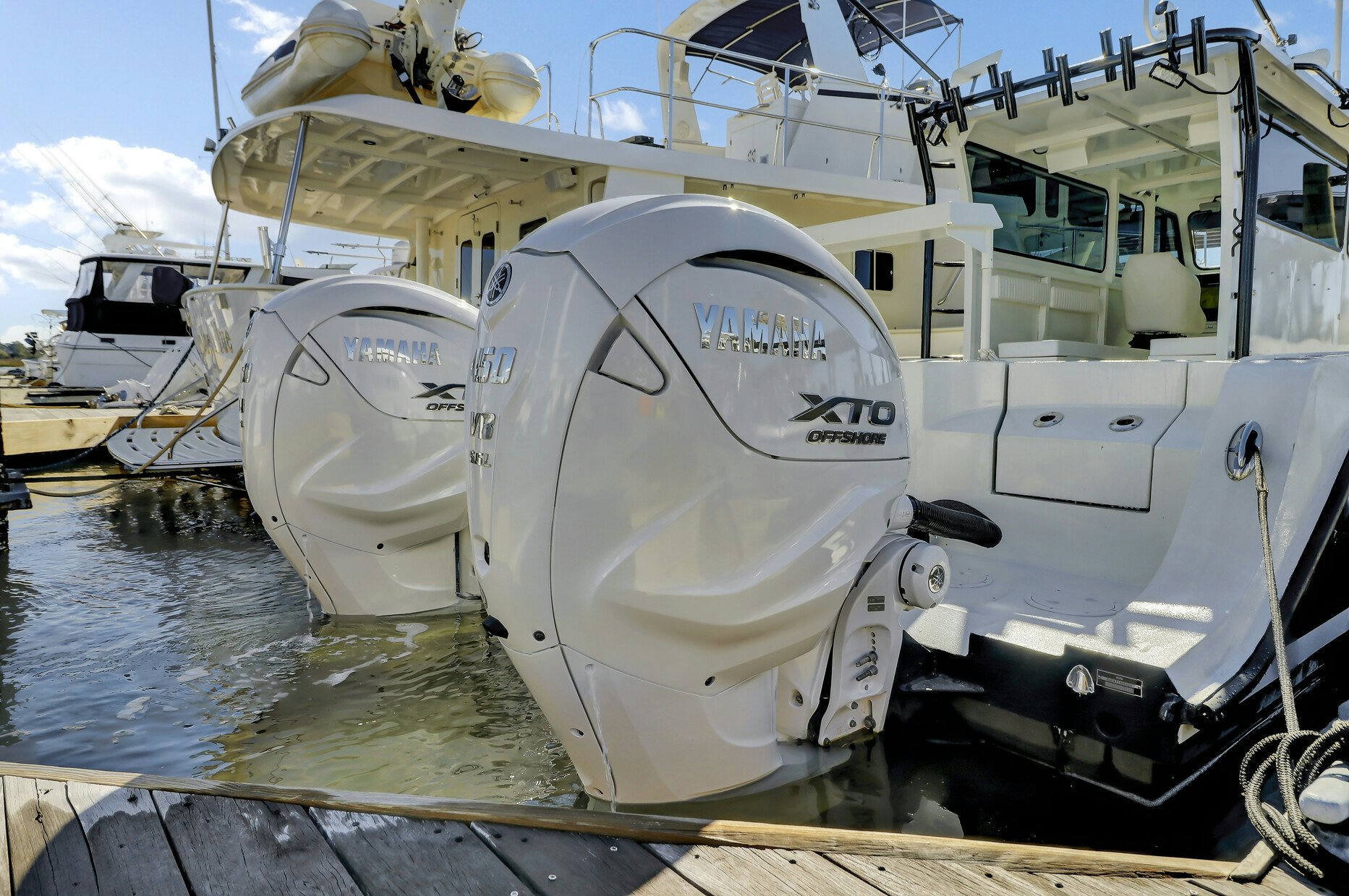 a large white boat on a dock aboard OUR TRADE Yacht for Sale
