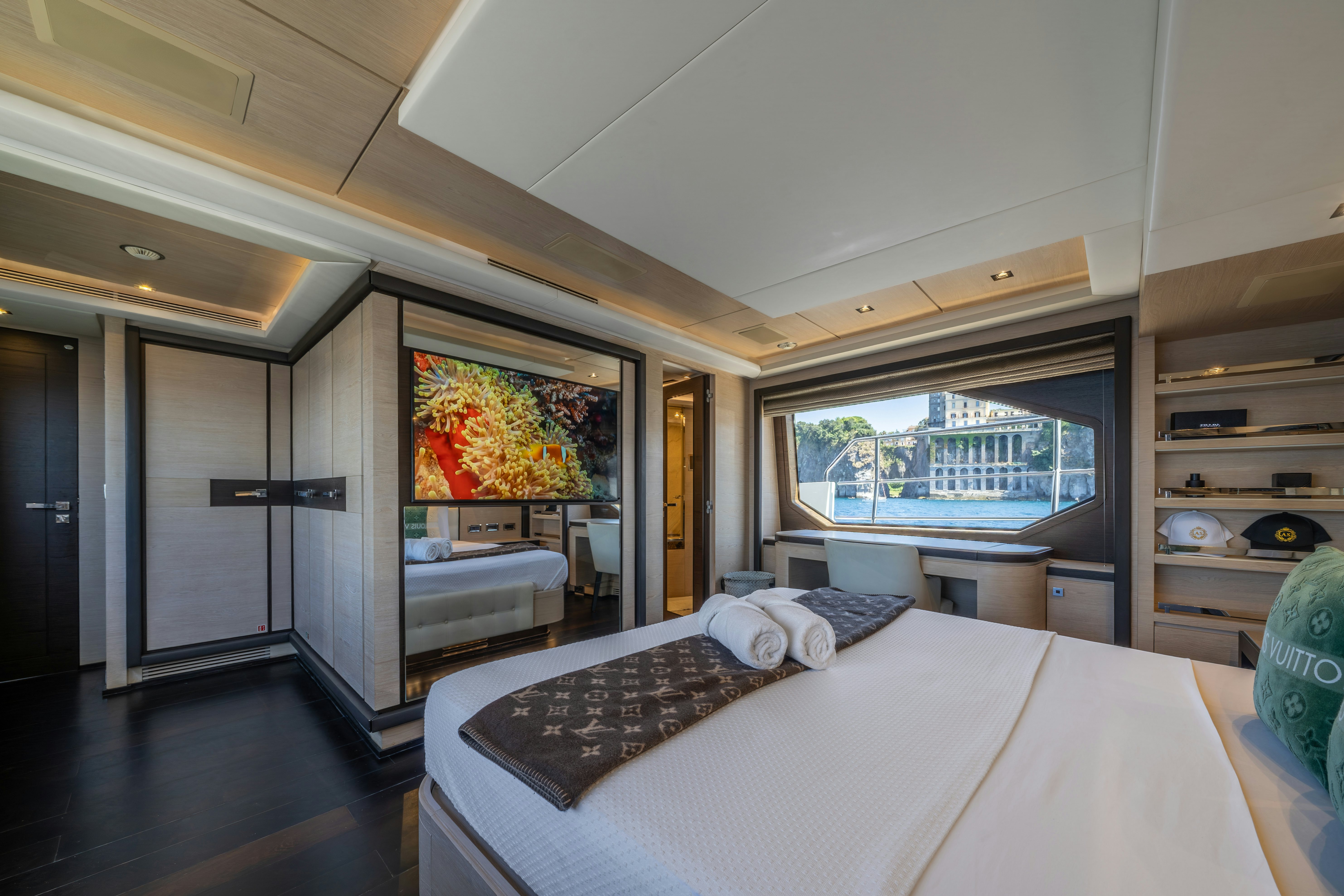 a bedroom with a large window aboard HORIZON Yacht for Sale