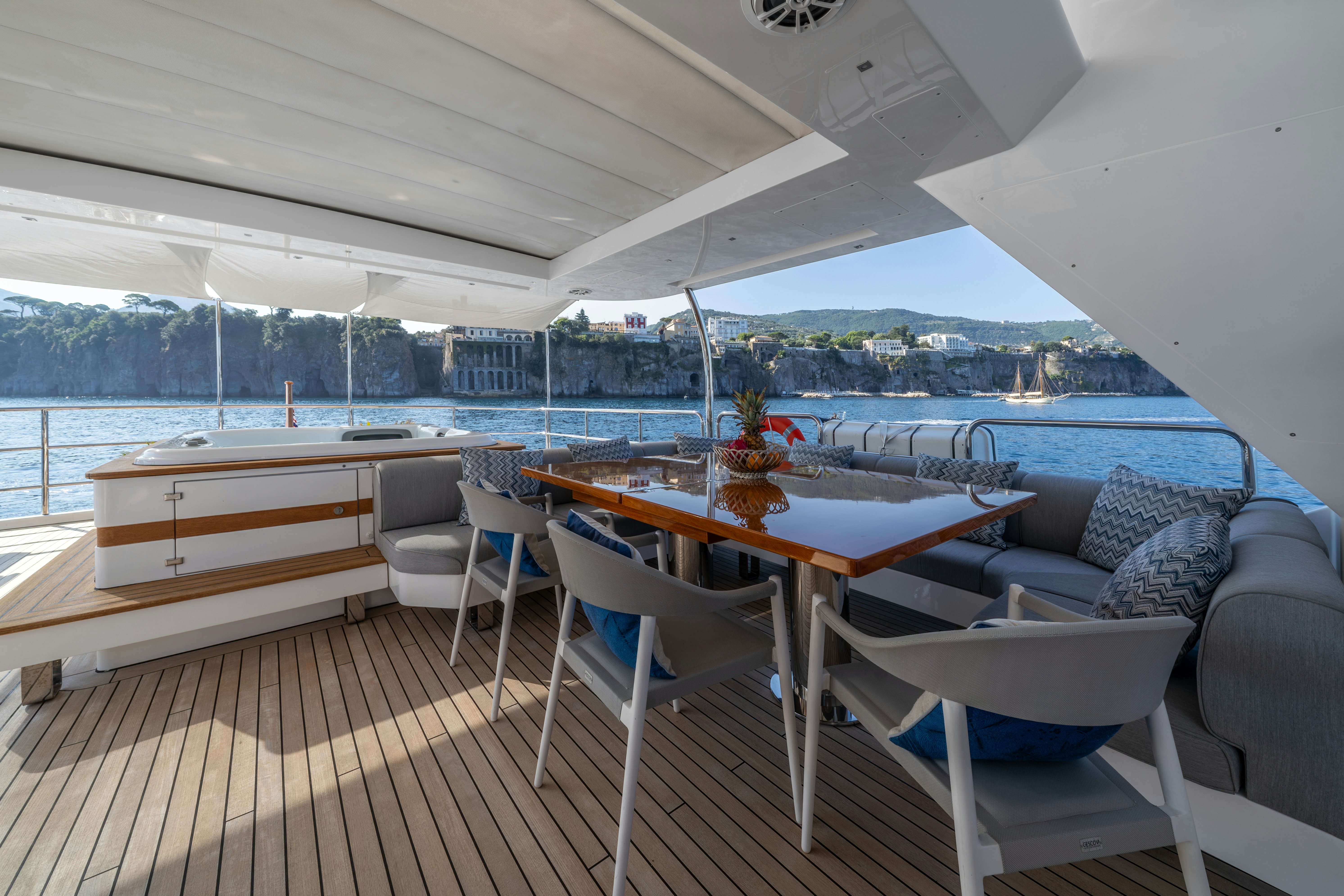 a table and chairs on a deck aboard HORIZON Yacht for Sale