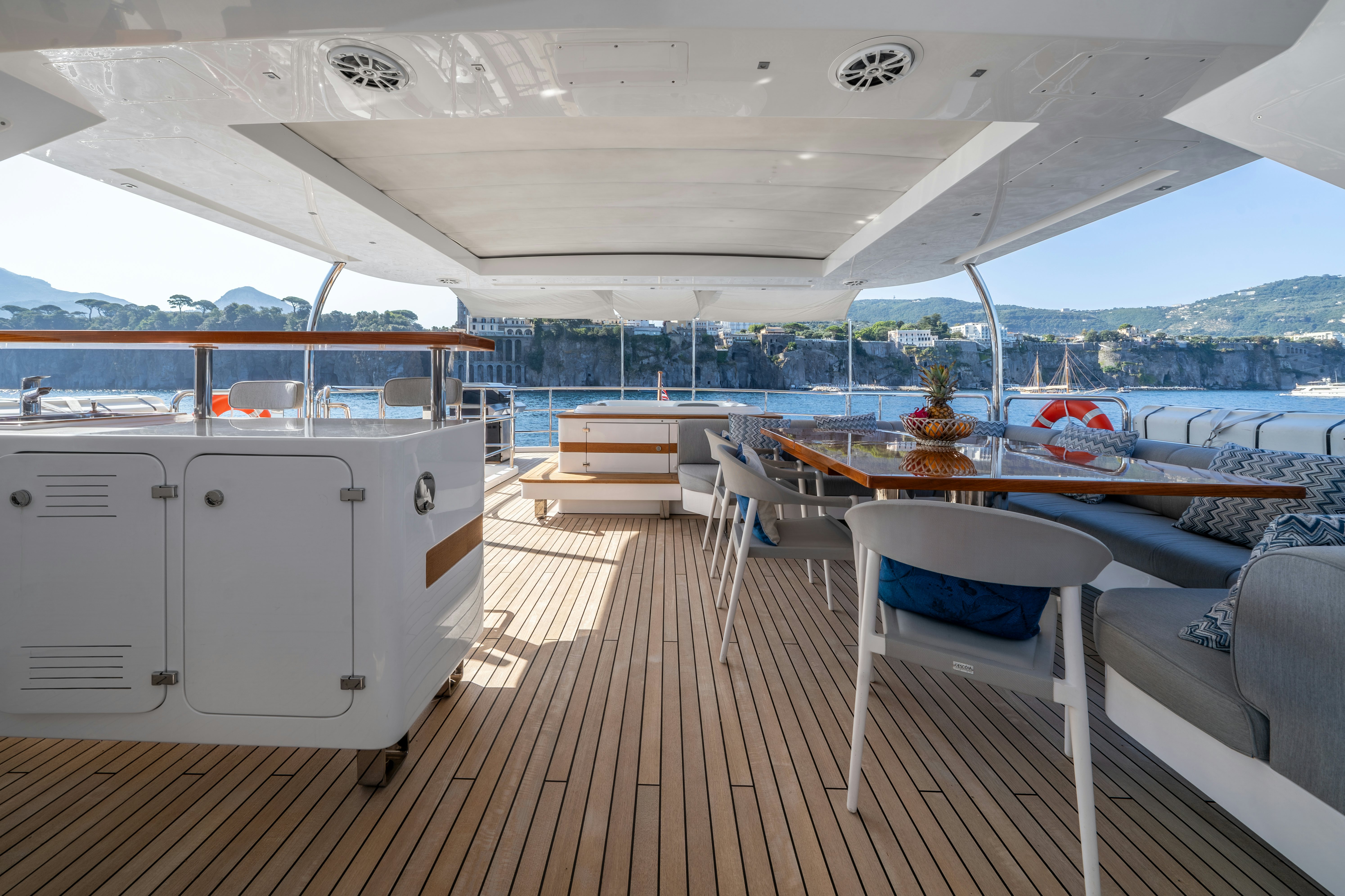 a deck with a view of the water and a city aboard HORIZON Yacht for Sale