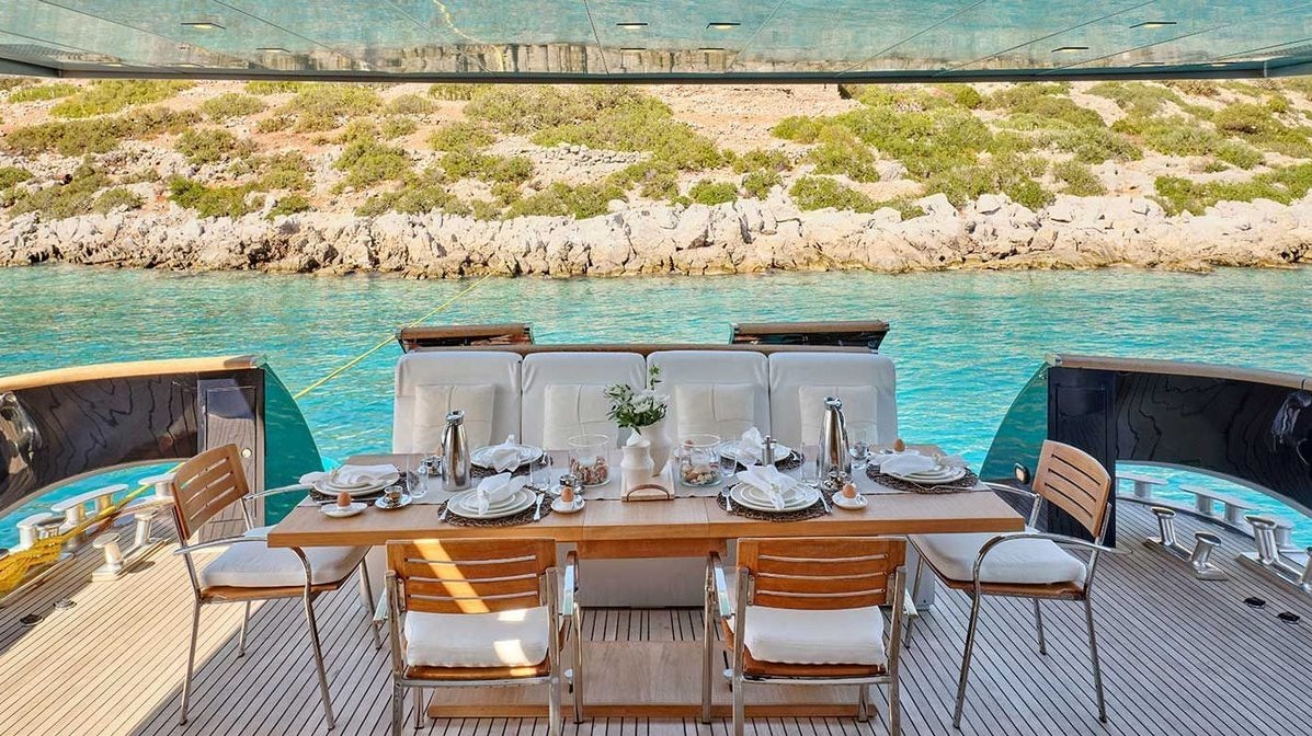 a table set for a dinner aboard AMICI PER SEMPRE Yacht for Charter