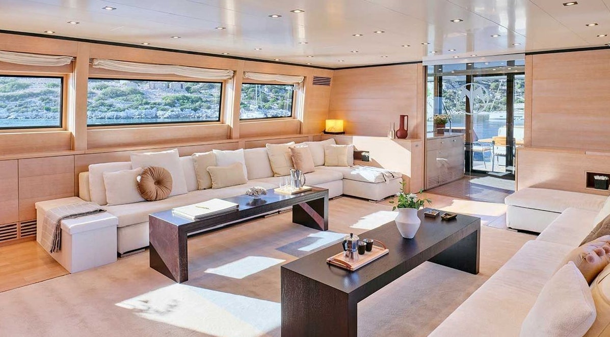 a living room with a couch and a coffee table aboard AMICI PER SEMPRE Yacht for Charter