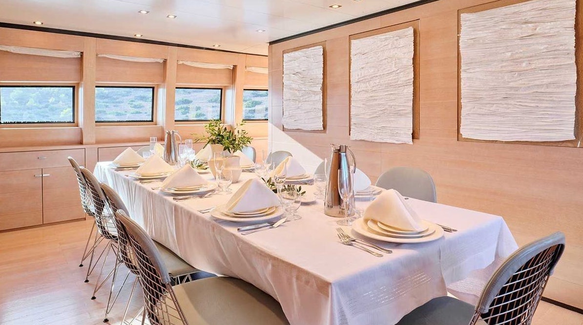 a table set for a dinner aboard AMICI PER SEMPRE Yacht for Charter