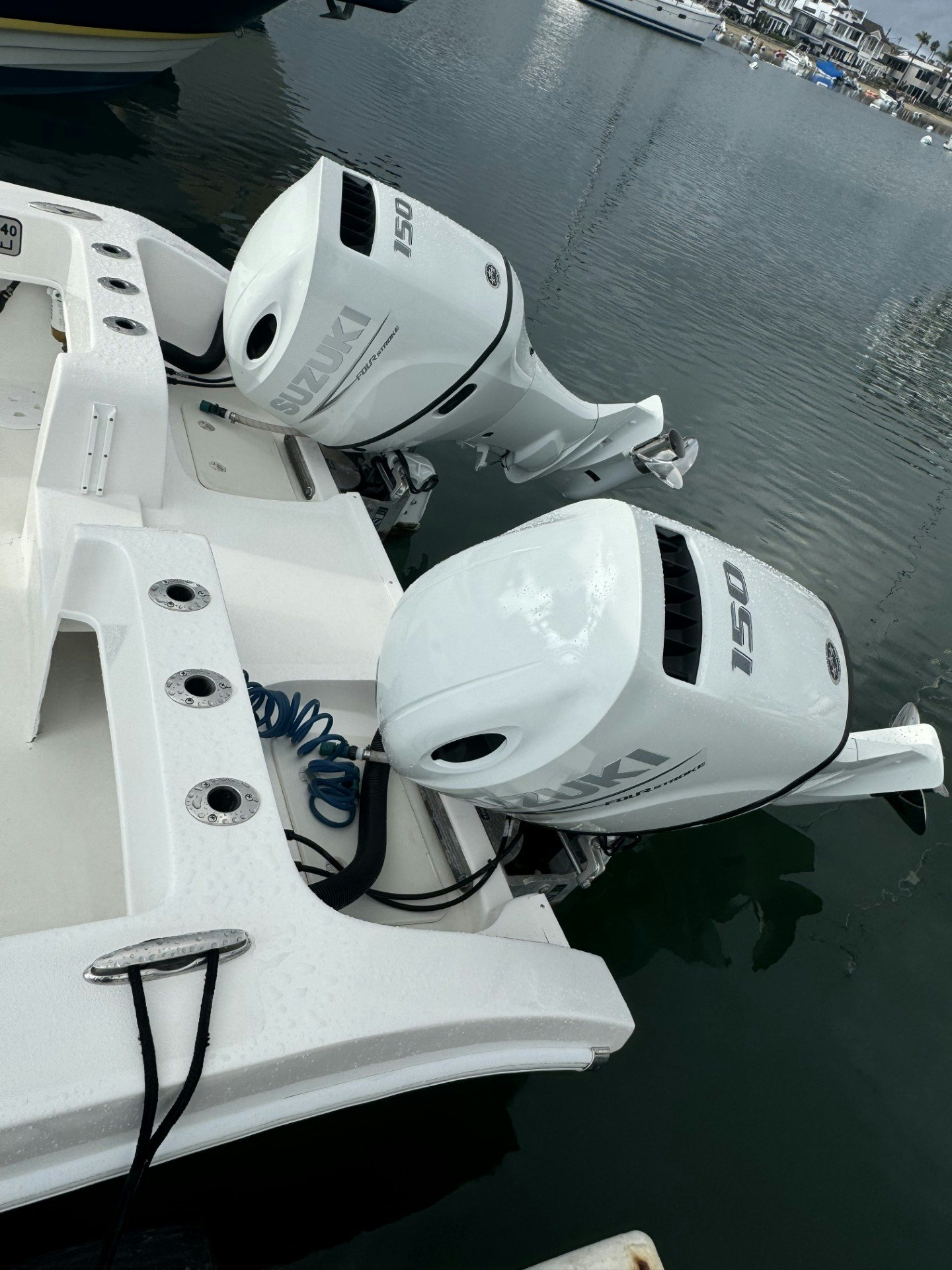 a white boat with a white propeller aboard TWIN VEE 26 Yacht for Sale