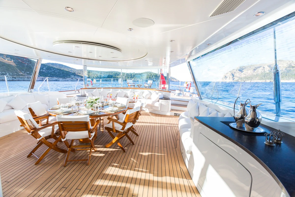 a room with a table and chairs aboard Q Yacht for Charter