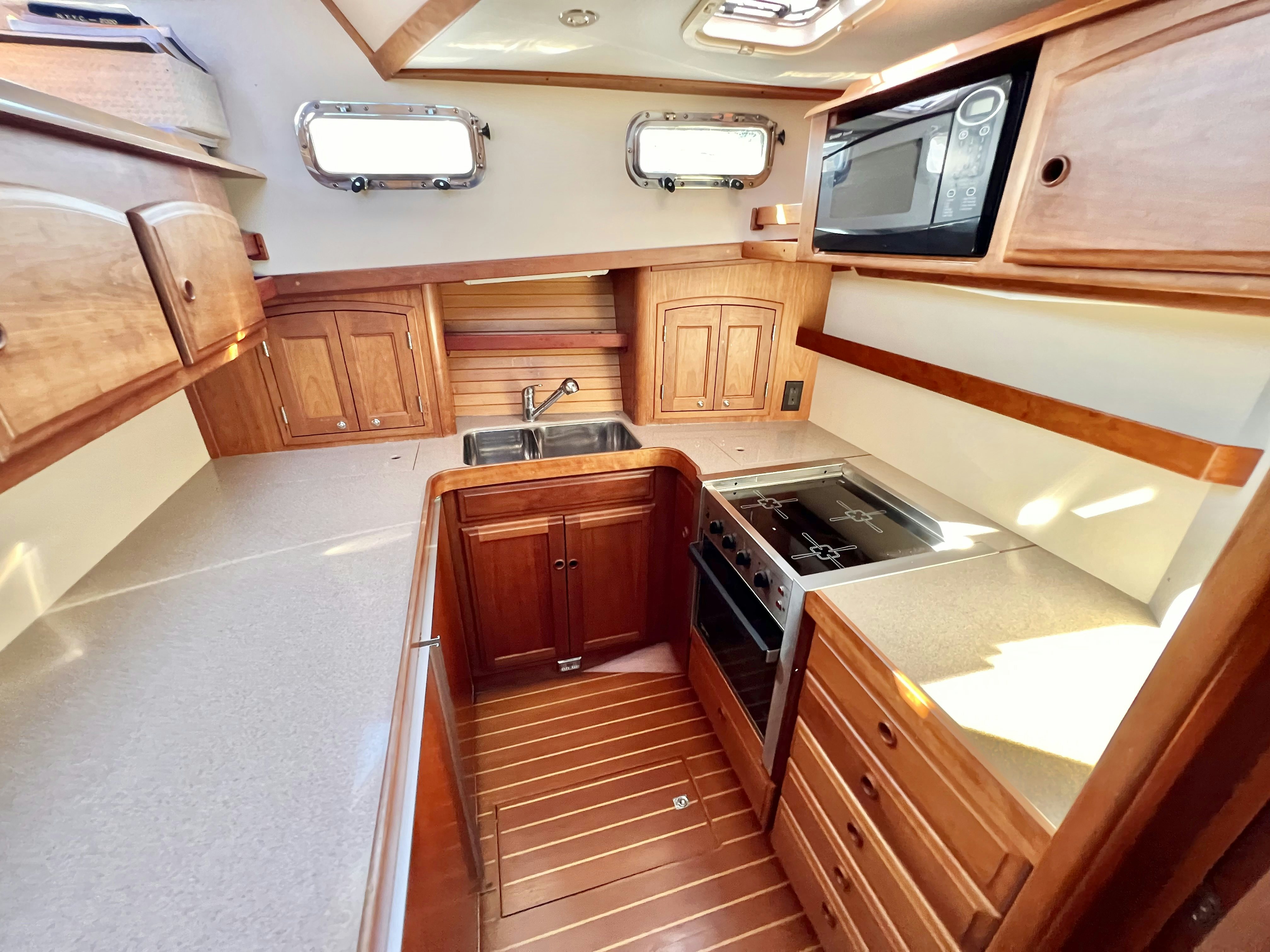 a kitchen with wooden cabinets aboard SWAMP FOX Yacht for Sale