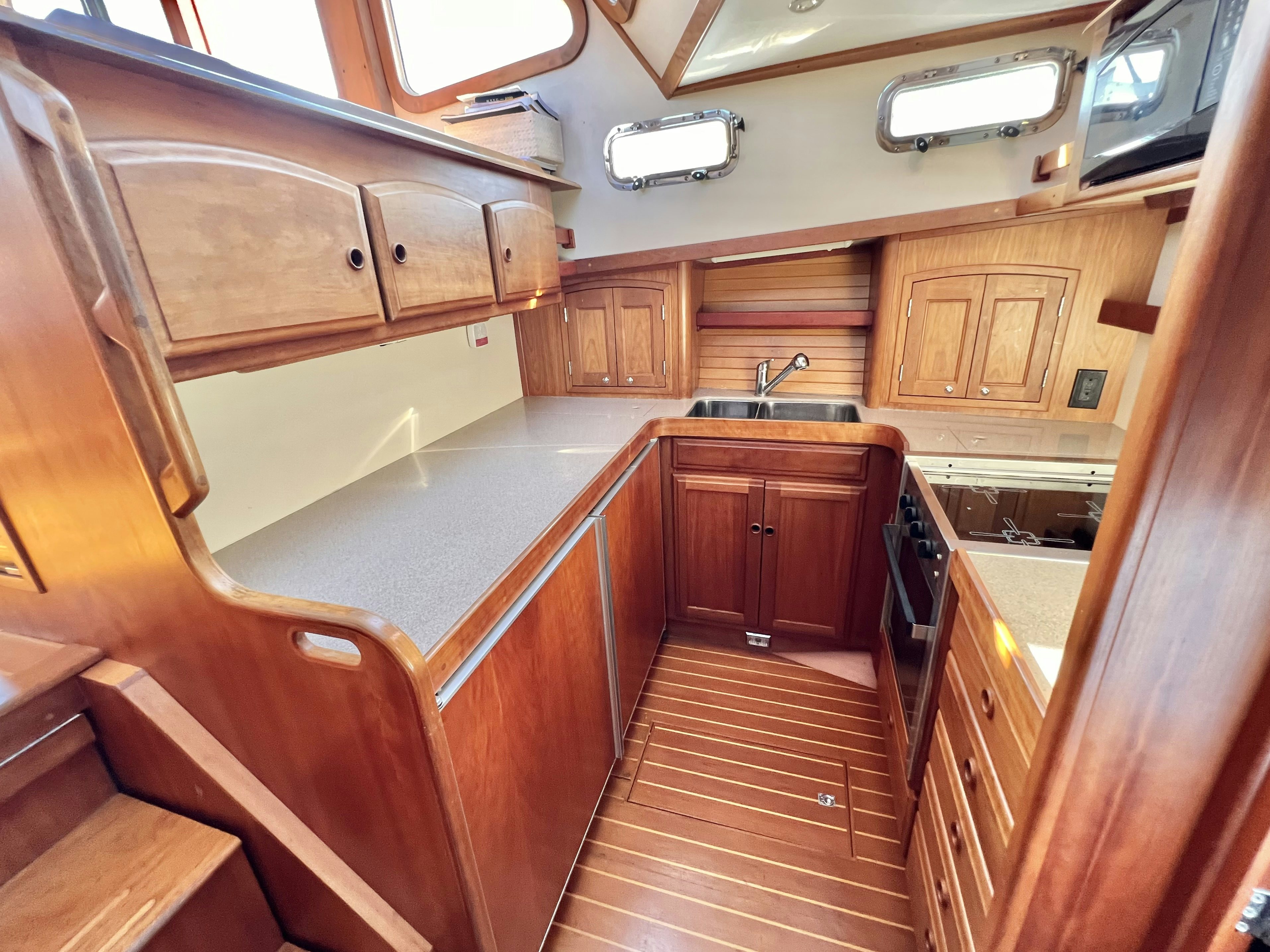 a kitchen with wooden cabinets aboard SWAMP FOX Yacht for Sale