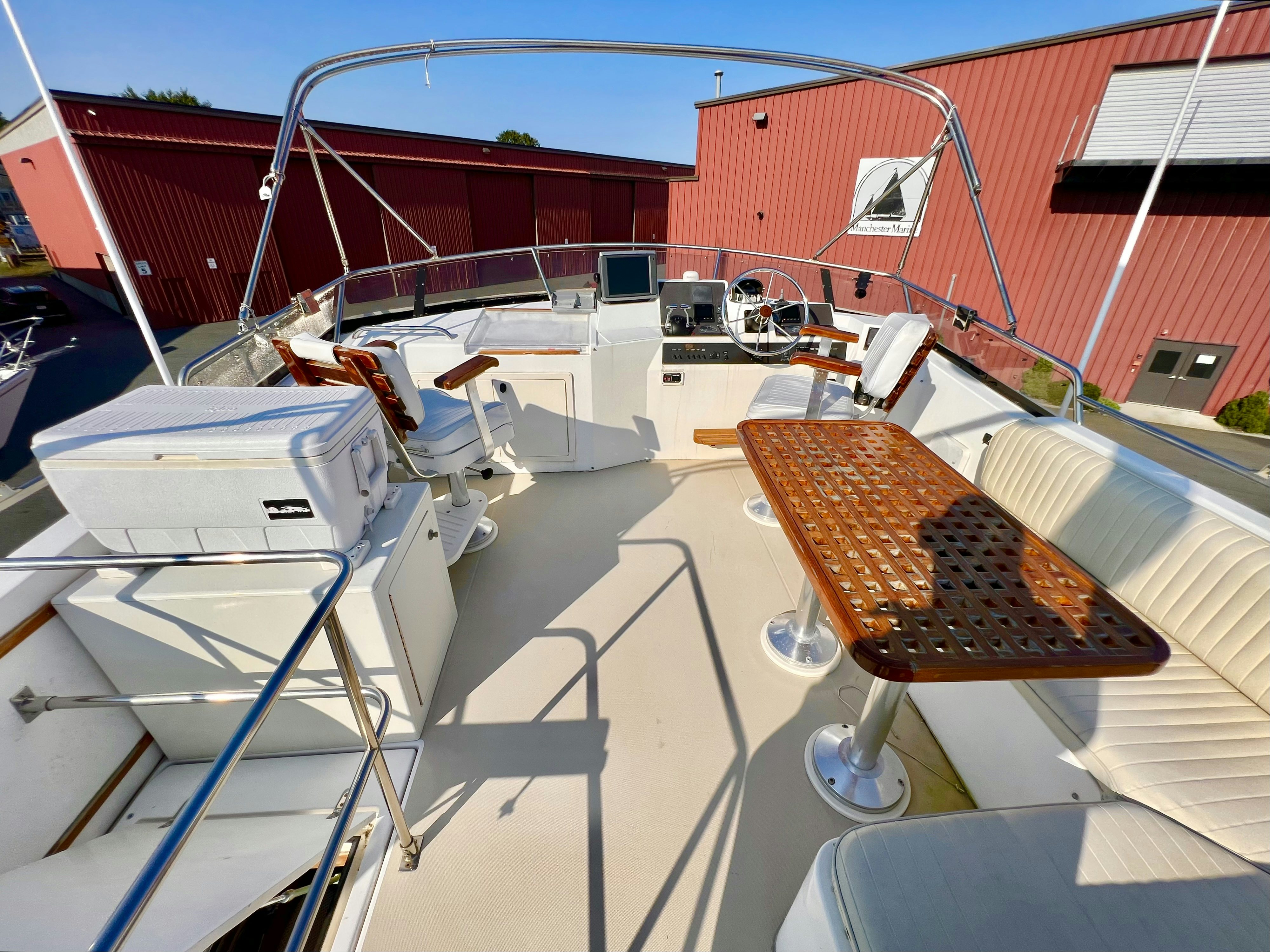 a deck with a boat and a grill aboard SWAMP FOX Yacht for Sale