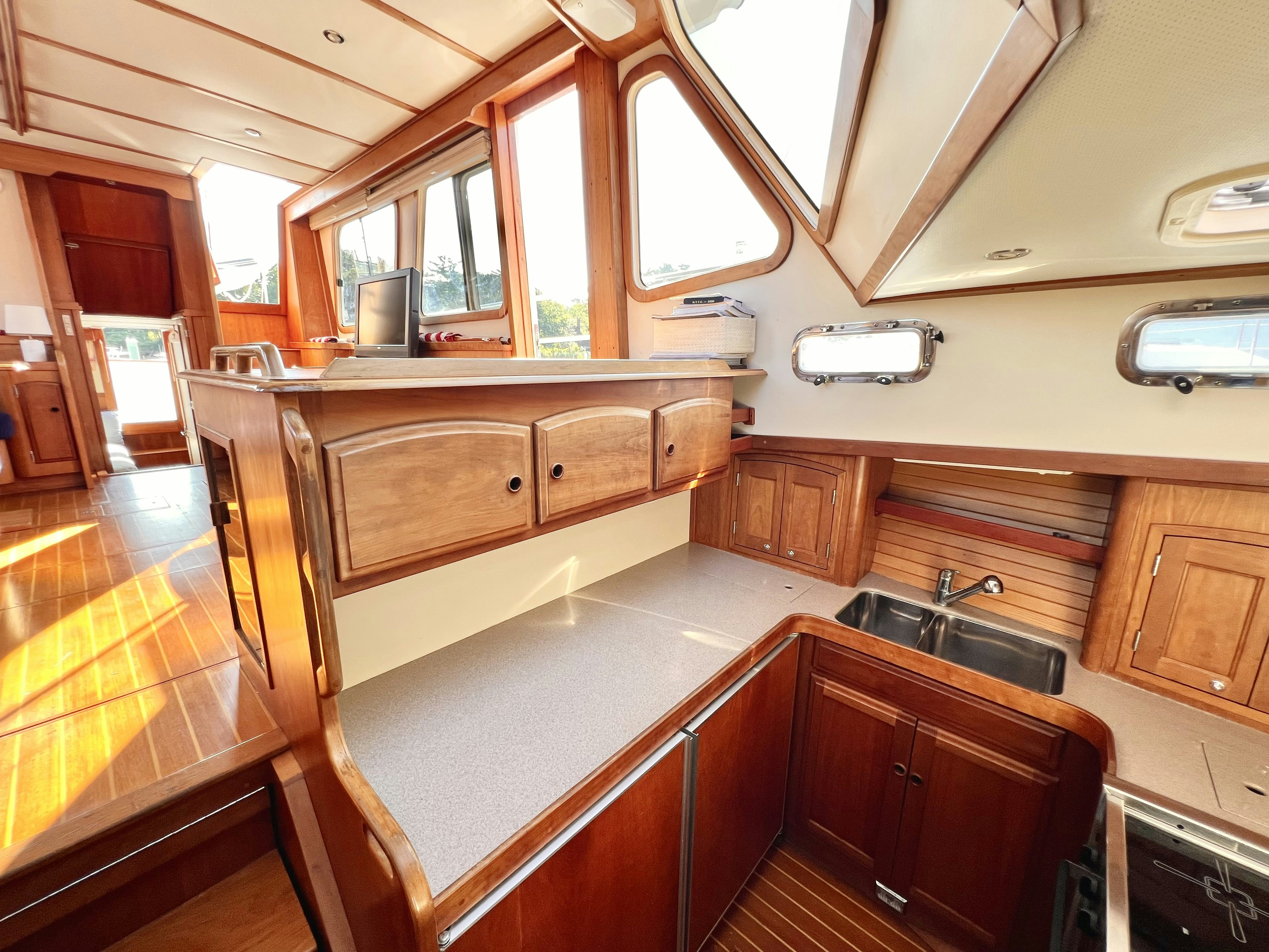 a kitchen with wooden cabinets aboard SWAMP FOX Yacht for Sale