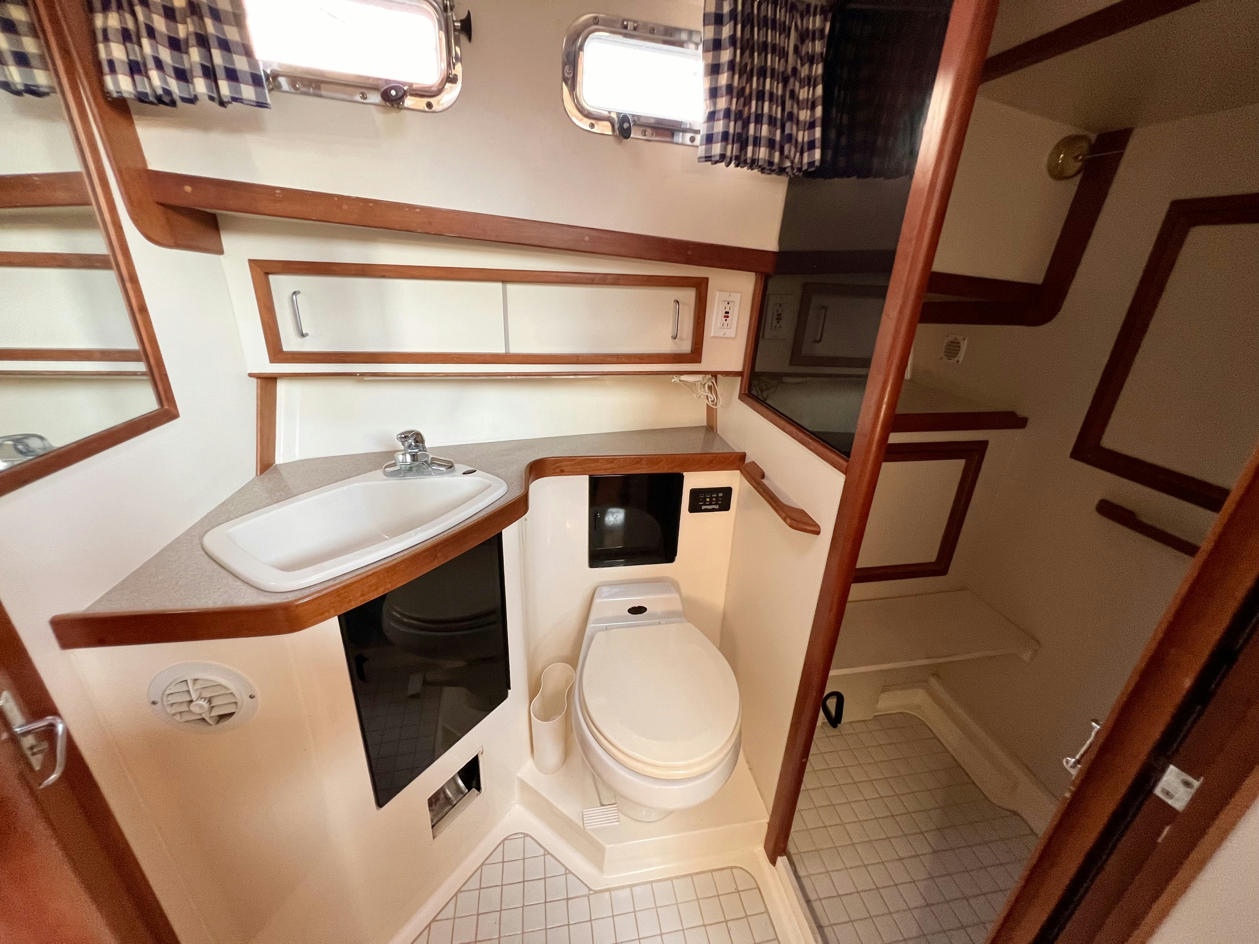 a bathroom with a toilet and sink aboard SWAMP FOX Yacht for Sale
