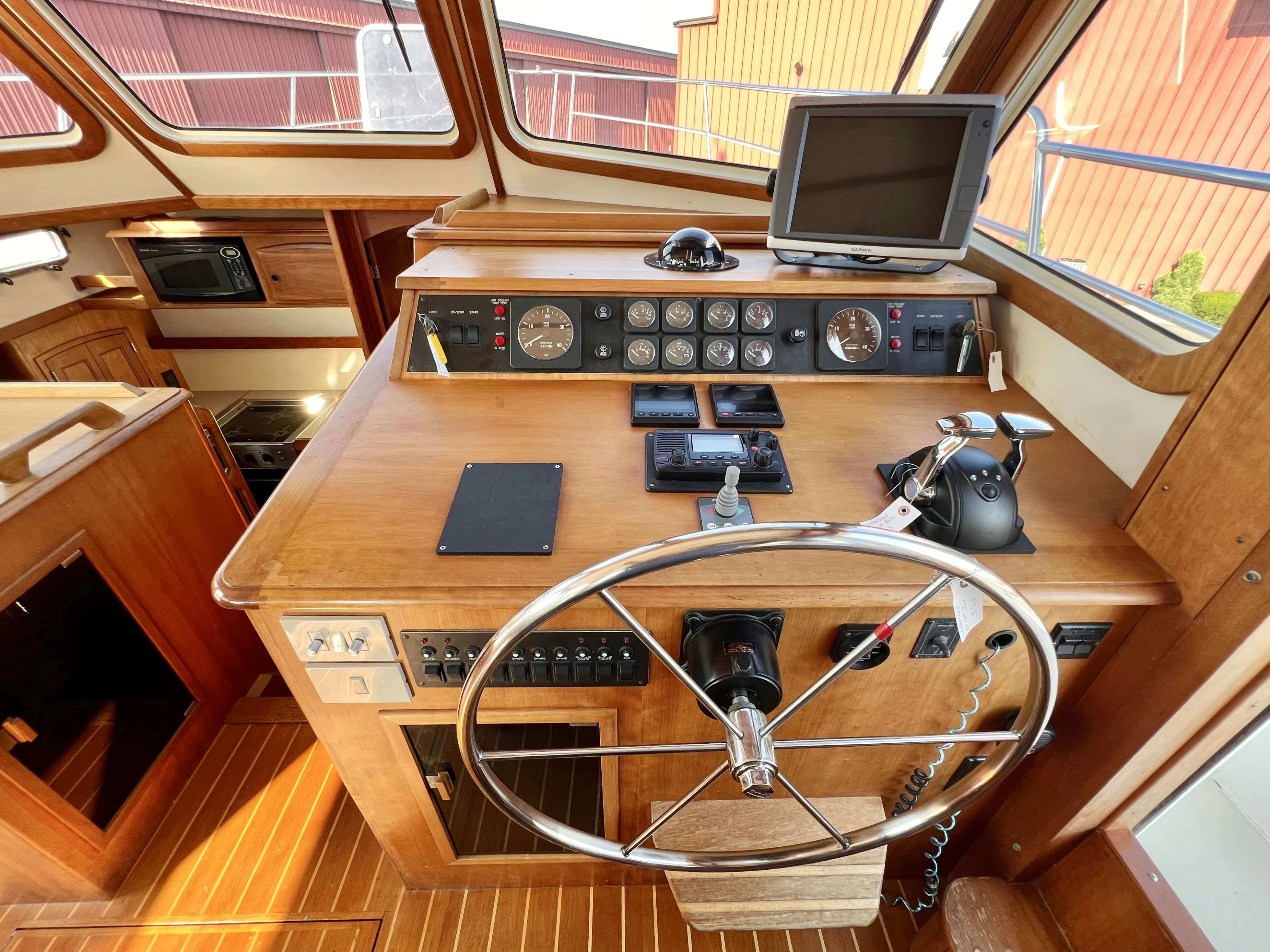 a wooden desk with a computer and a television on it aboard SWAMP FOX Yacht for Sale
