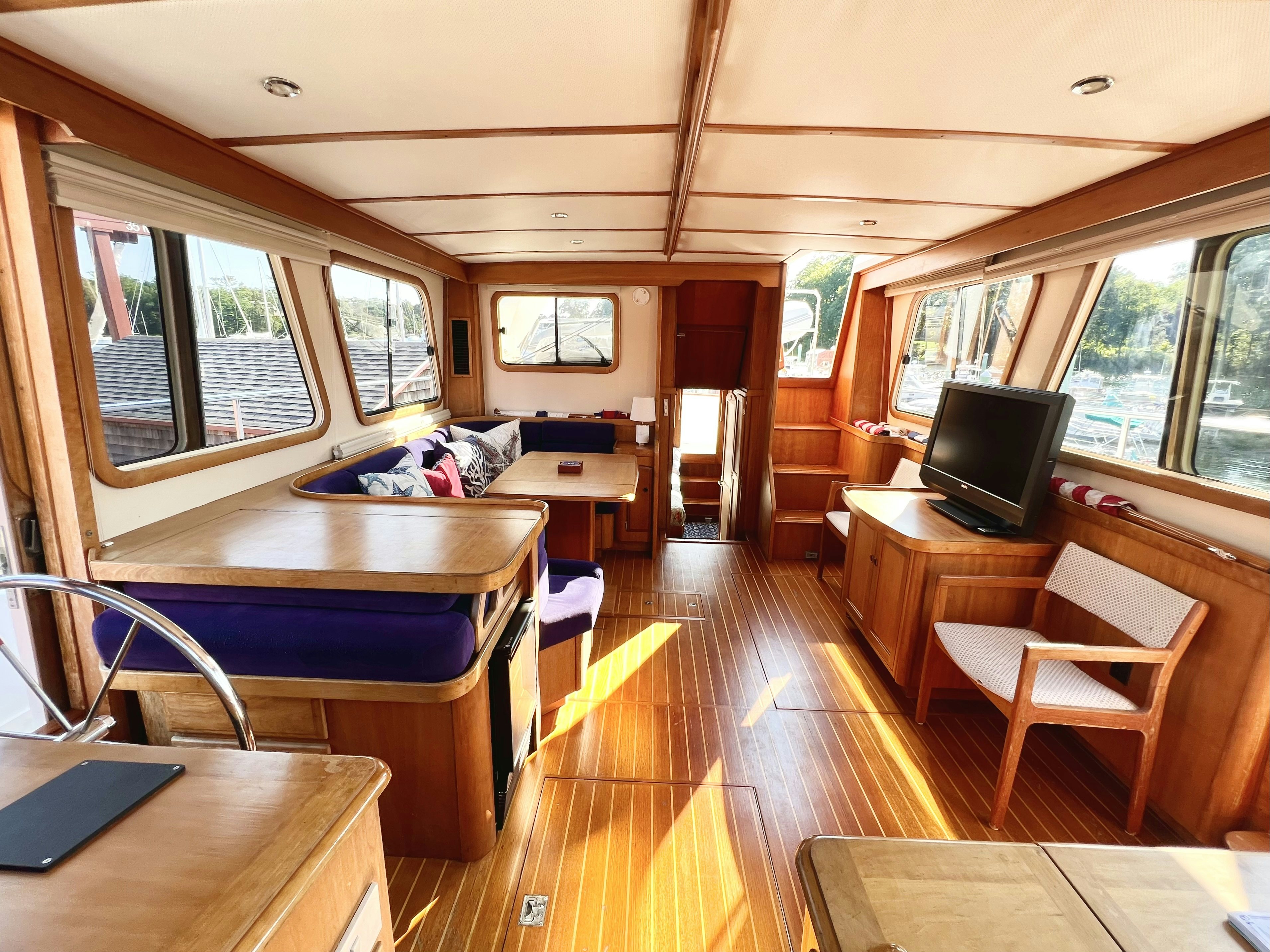 a room with a wood floor and a tv on the wall aboard SWAMP FOX Yacht for Sale