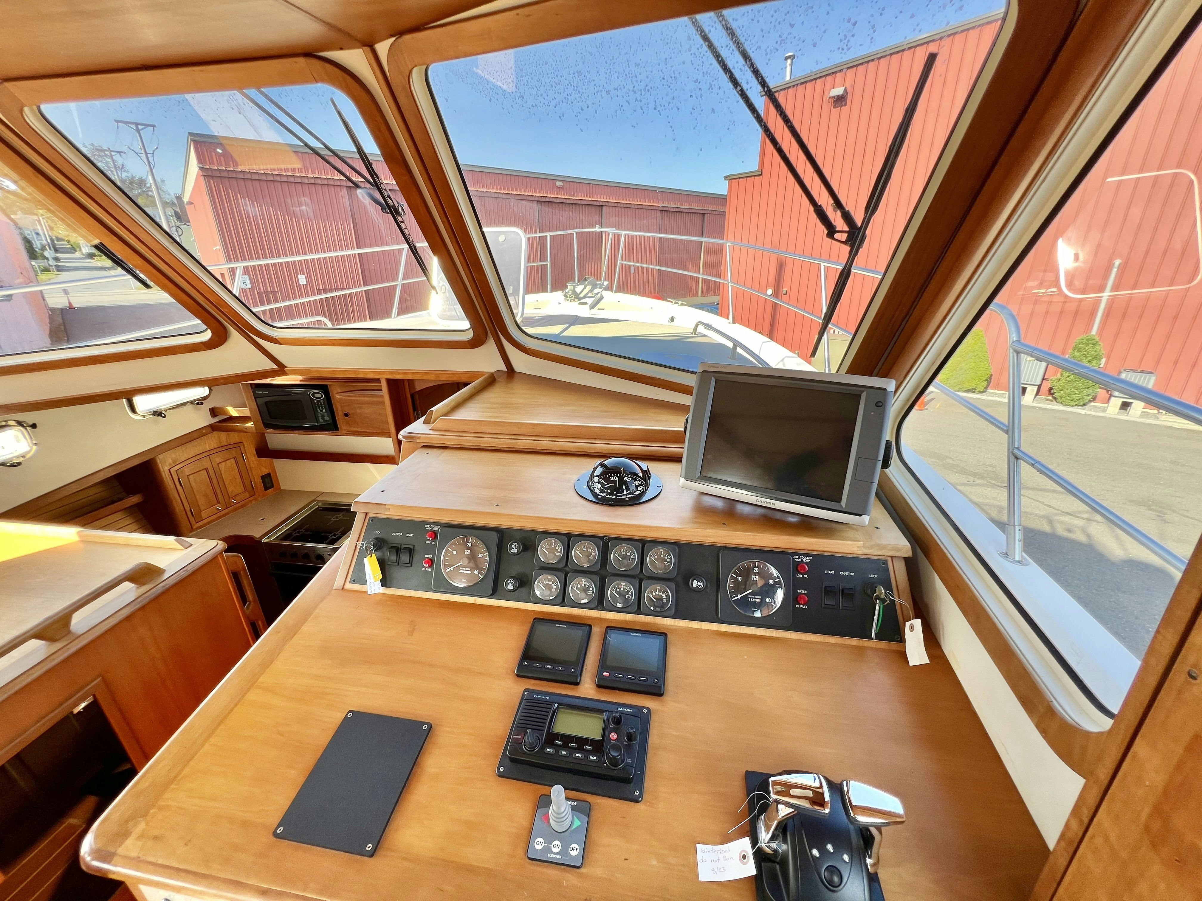 a desk with a computer and a television on it aboard SWAMP FOX Yacht for Sale