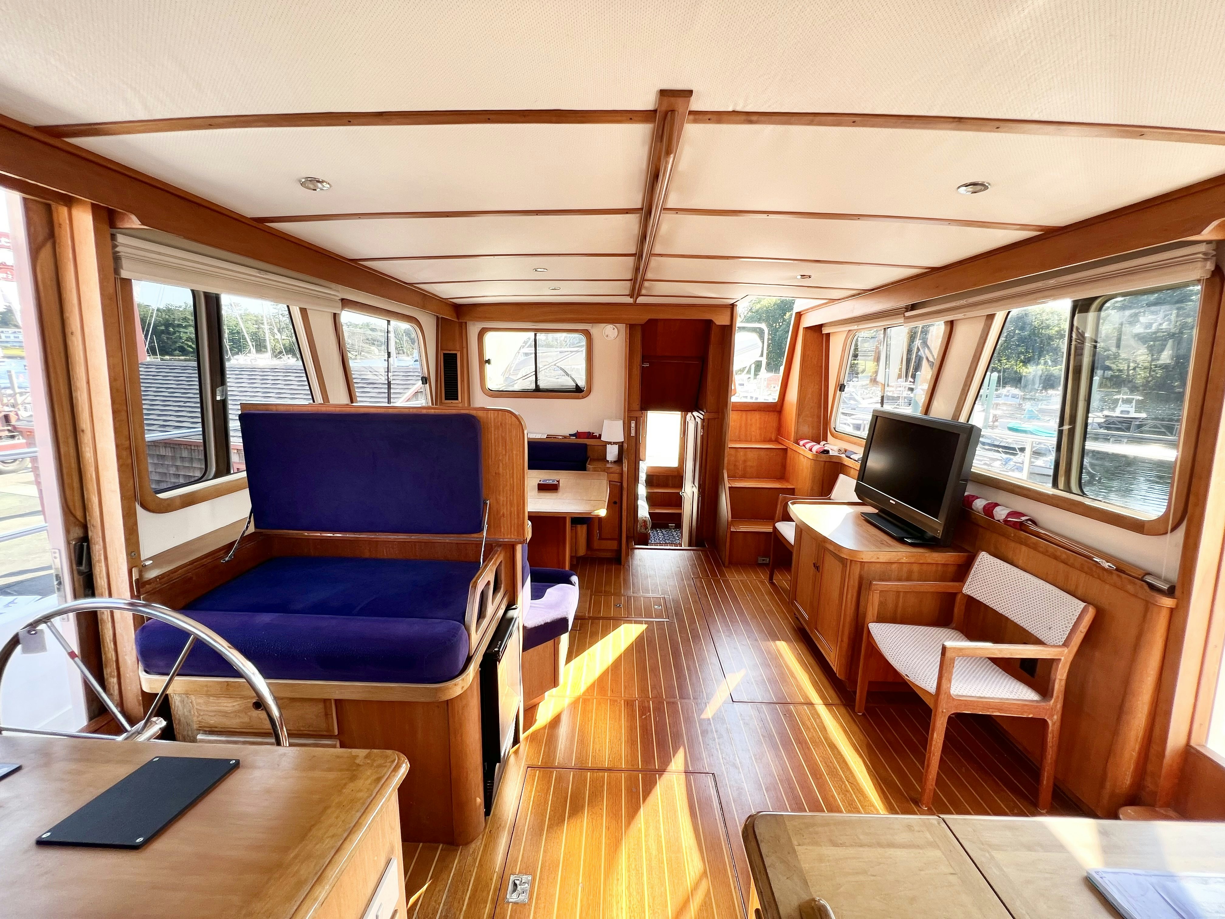 a room with a wood floor and a tv on a table aboard SWAMP FOX Yacht for Sale