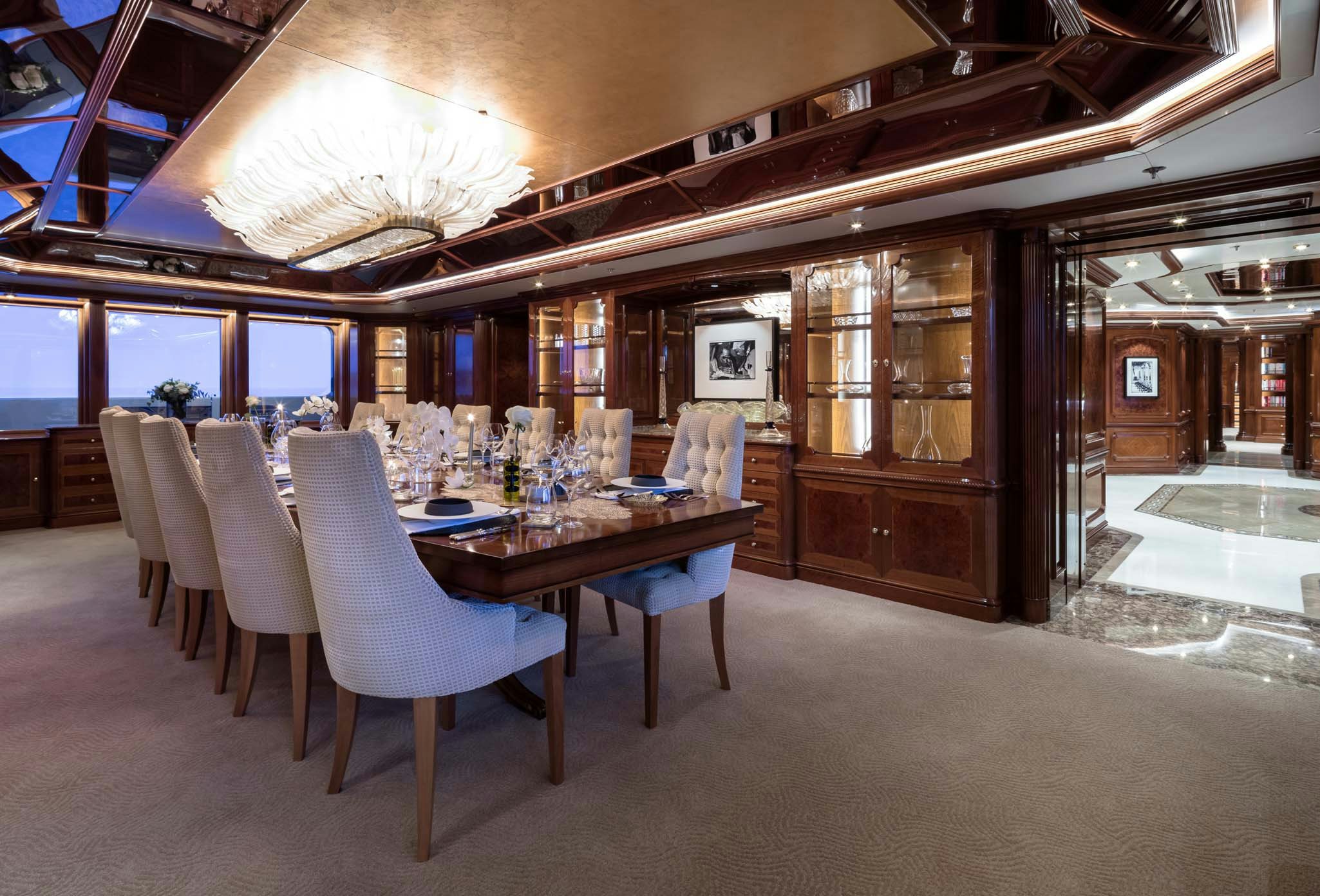 a large room with tables and chairs aboard STARFIRE Yacht for Charter
