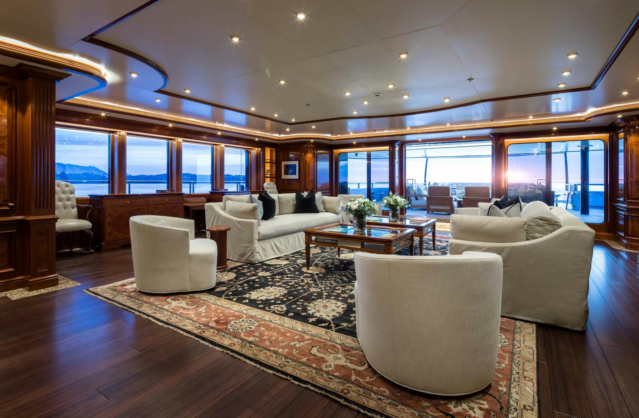 a living room with a large window aboard STARFIRE Yacht for Charter