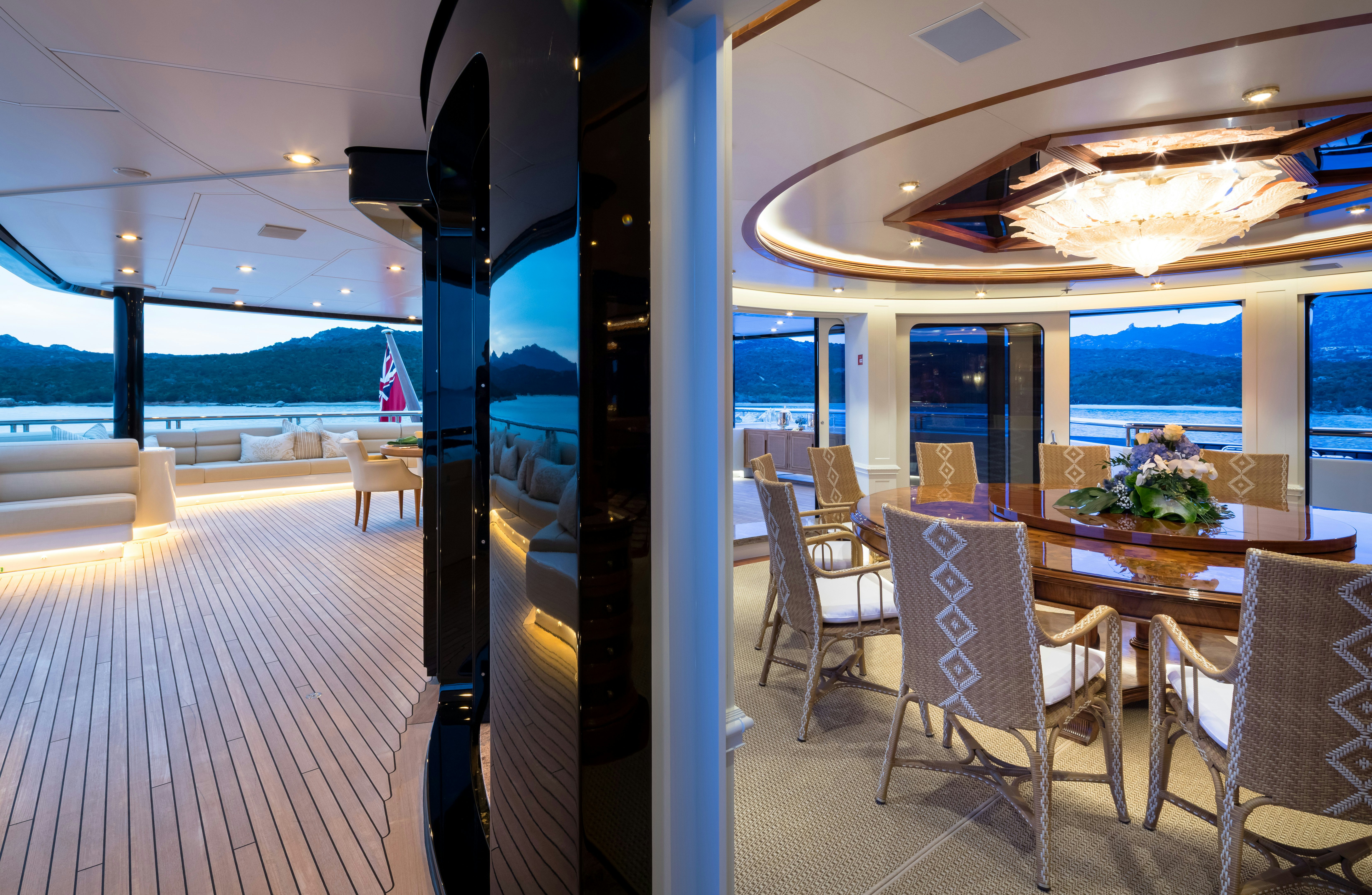a room with tables and chairs aboard STARFIRE Yacht for Charter
