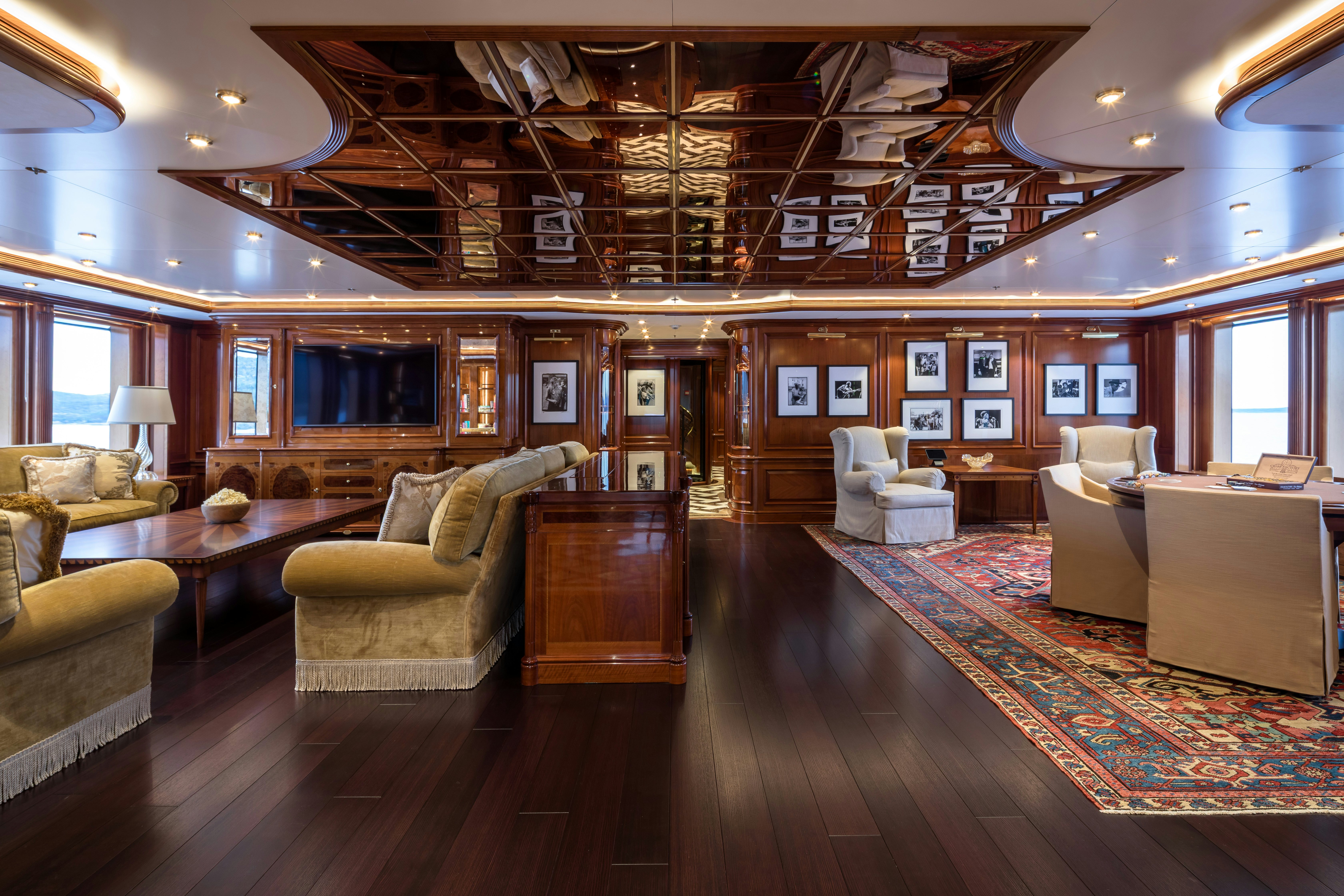 a living room with a large wood floor aboard STARFIRE Yacht for Charter
