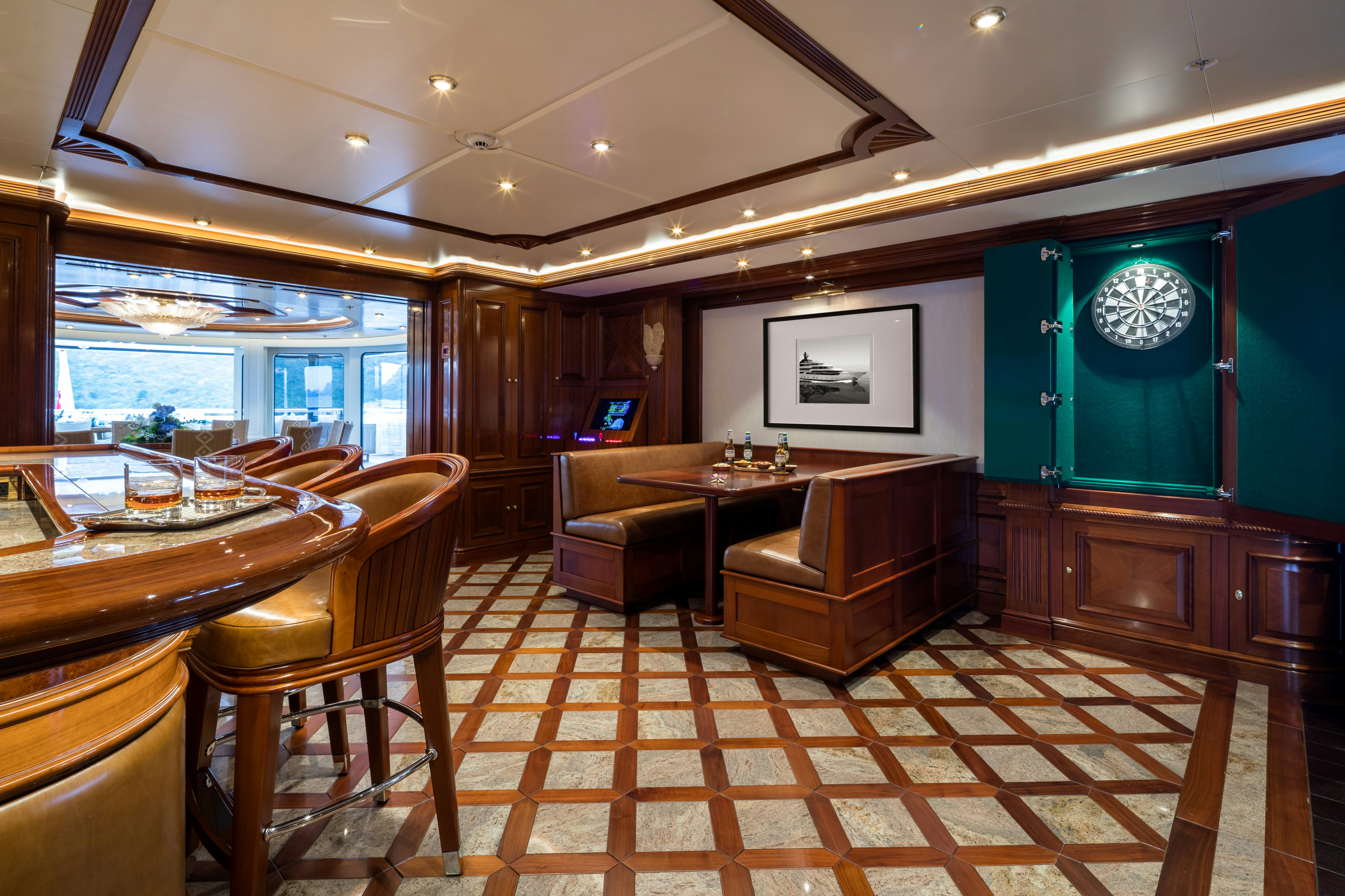 a large room with a table and chairs aboard STARFIRE Yacht for Charter