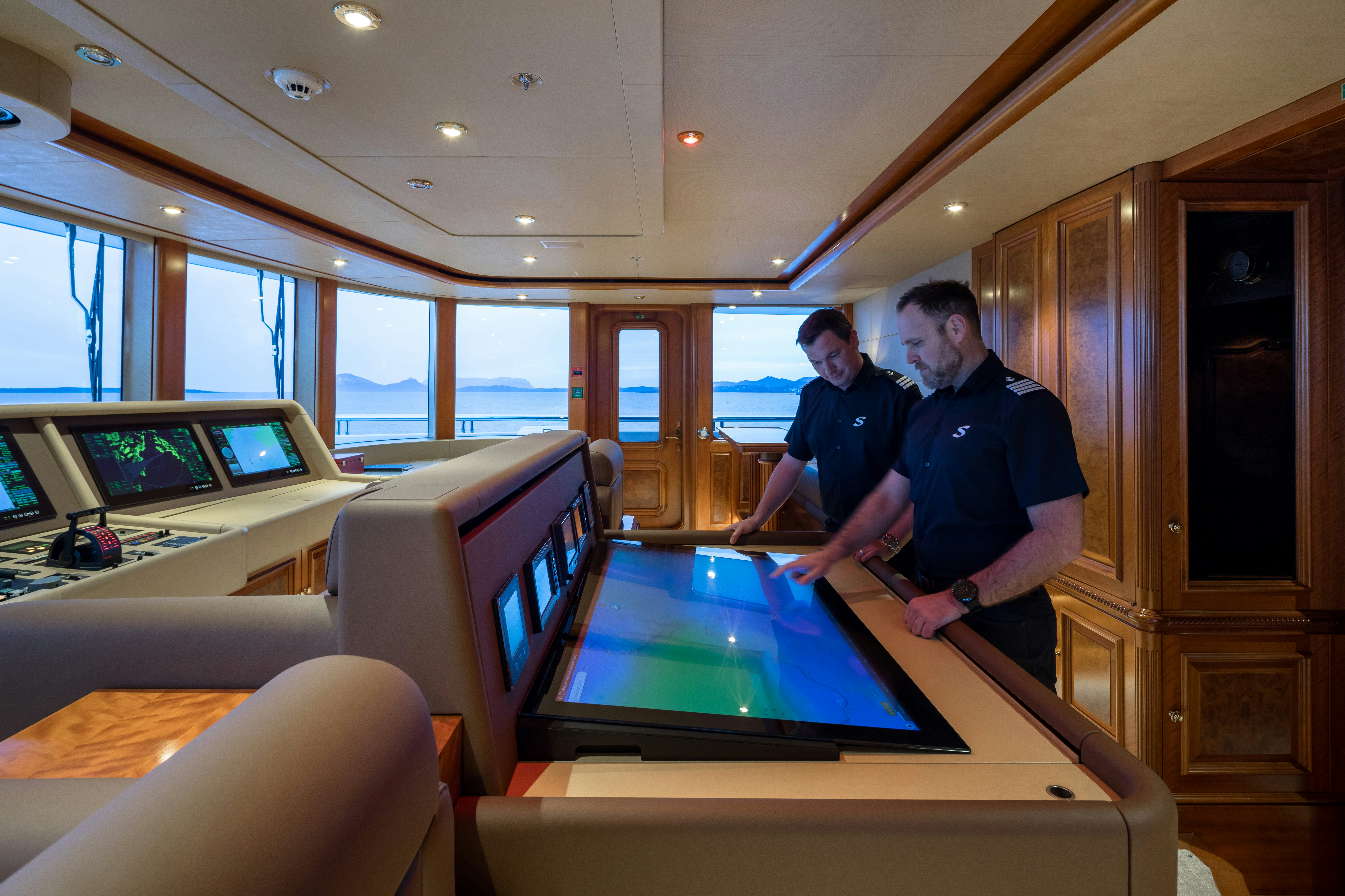 men in a control room aboard STARFIRE Yacht for Charter