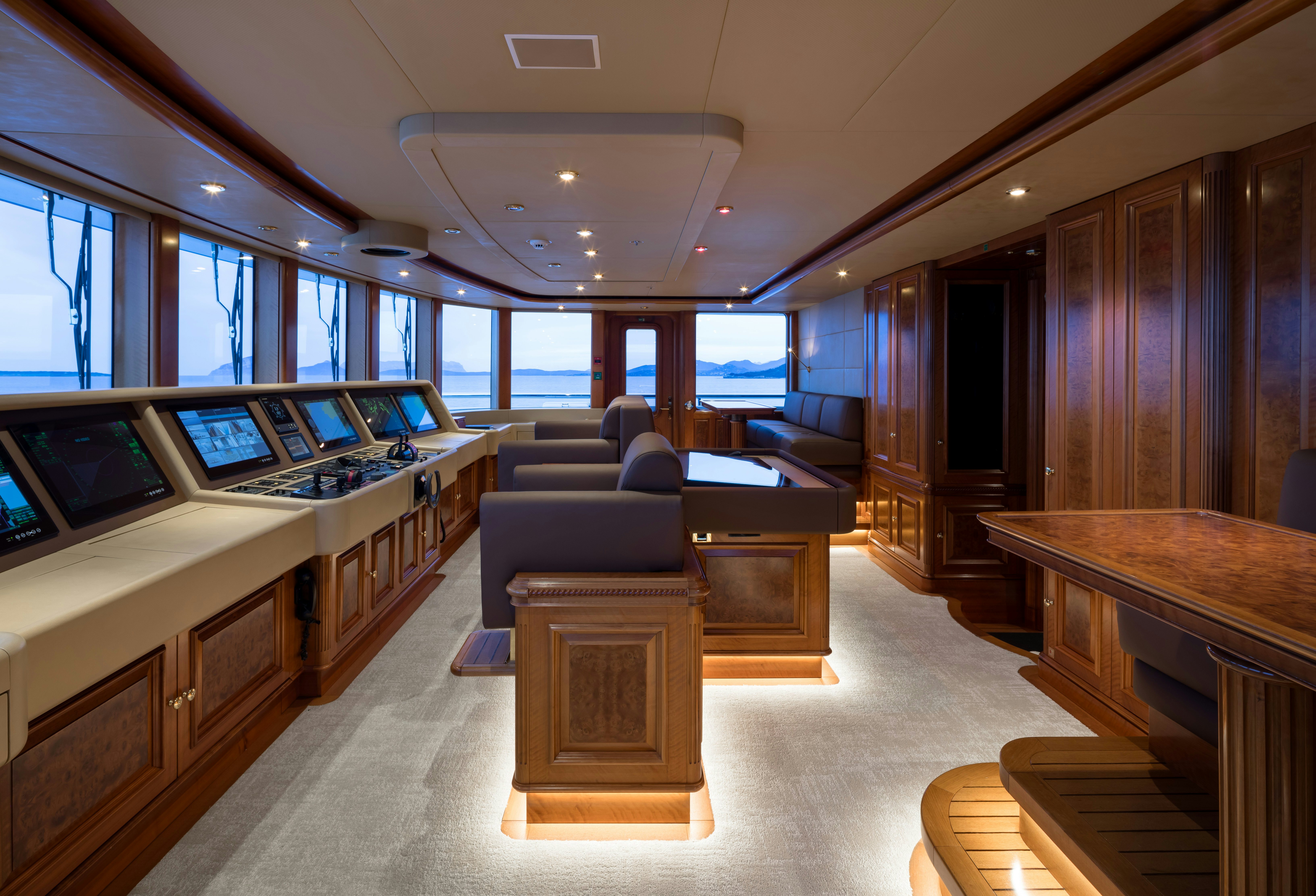 a room with a couch and a table with a laptop on it aboard STARFIRE Yacht for Charter