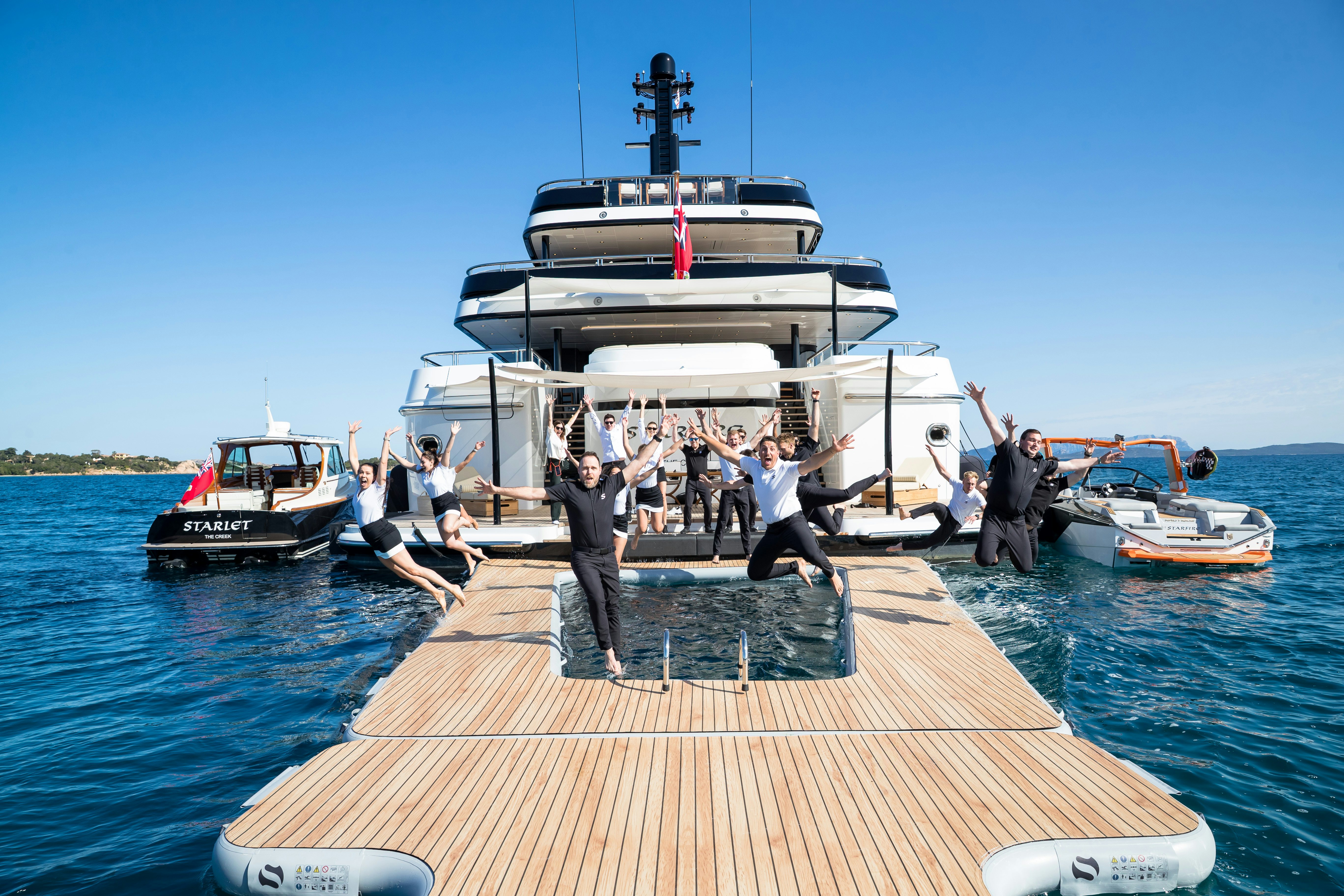 a group of people on a boat aboard STARFIRE Yacht for Charter