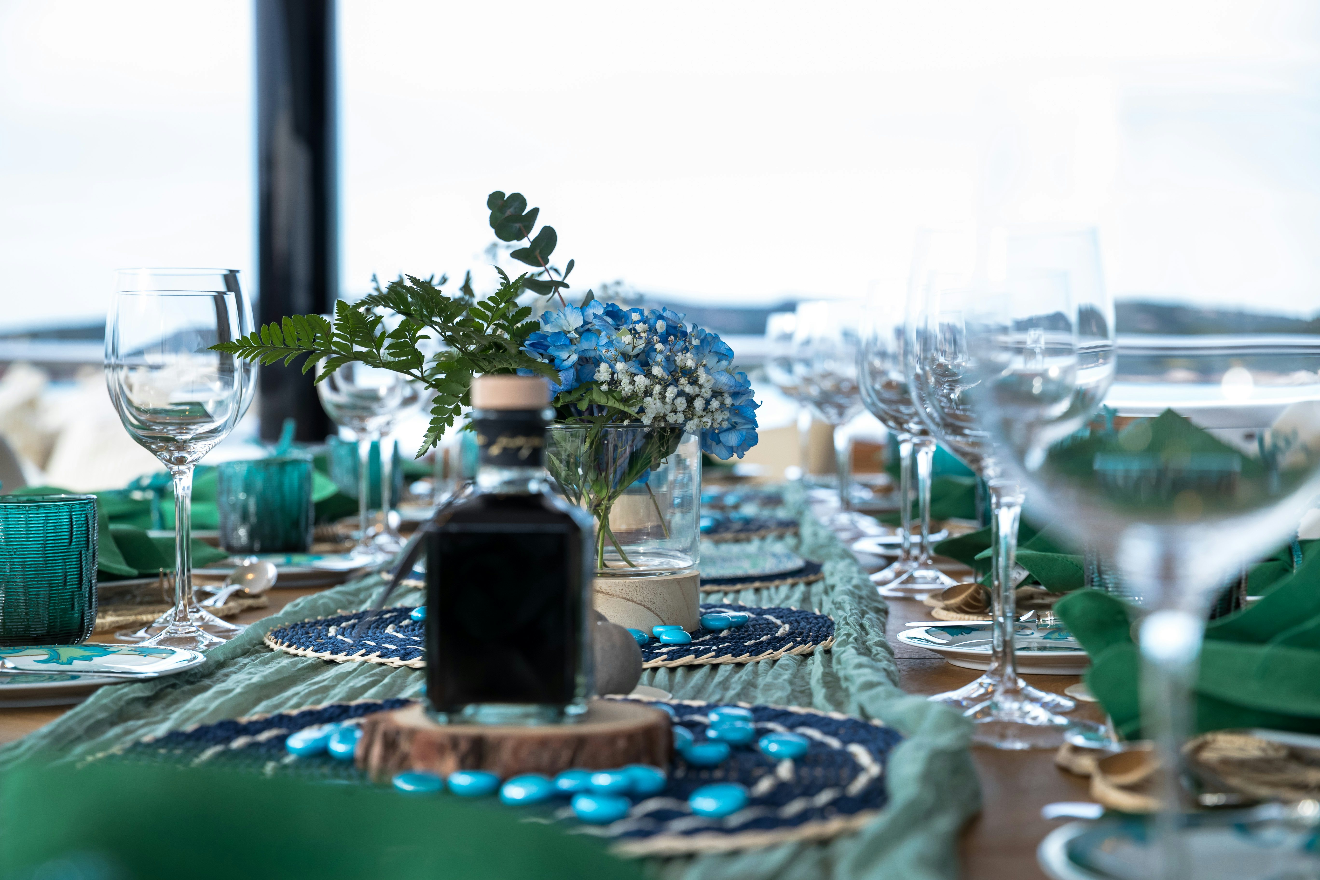 a table with wine glasses and food on it aboard STARFIRE Yacht for Charter