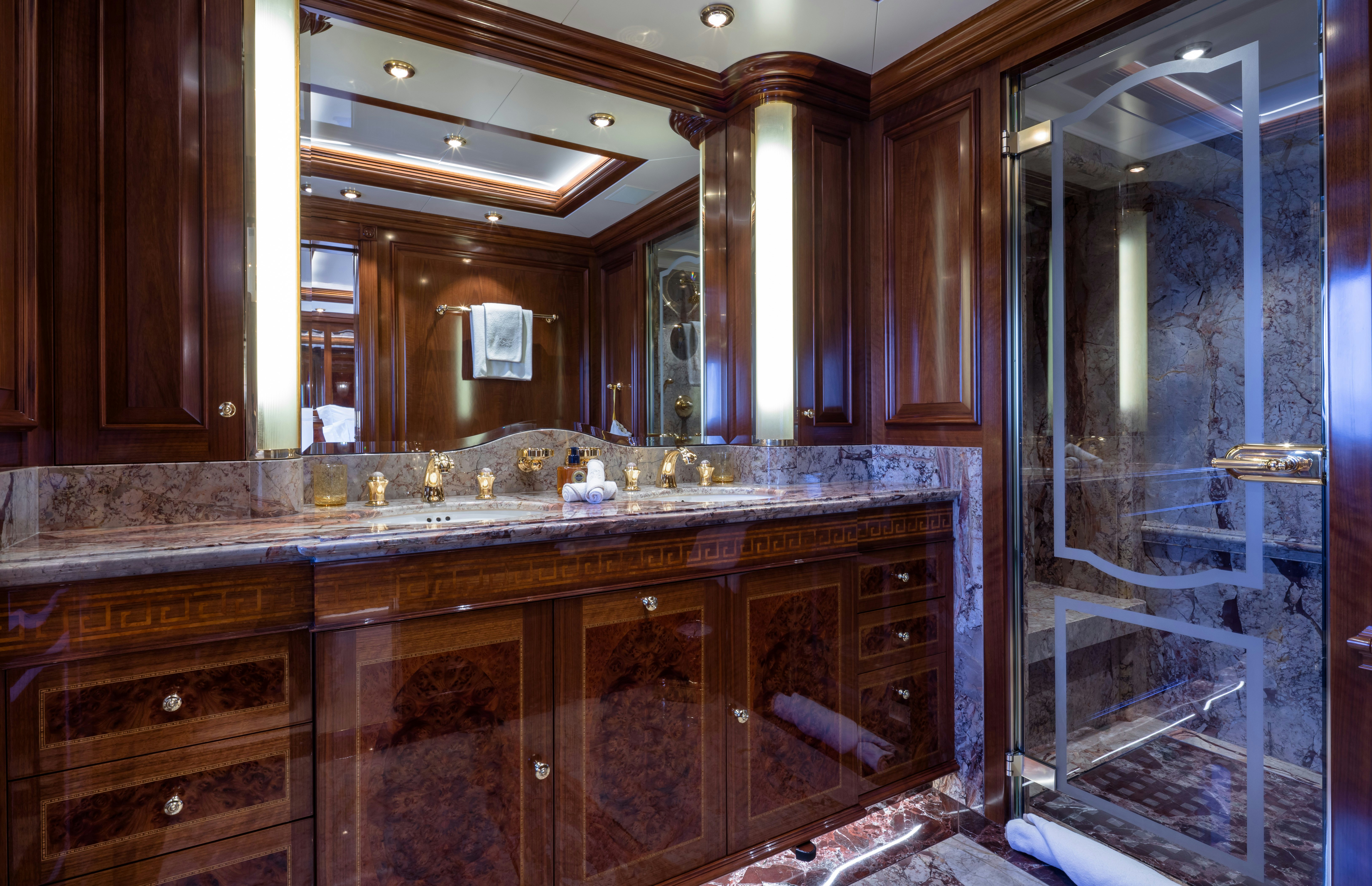 a bathroom with a glass shower aboard STARFIRE Yacht for Charter