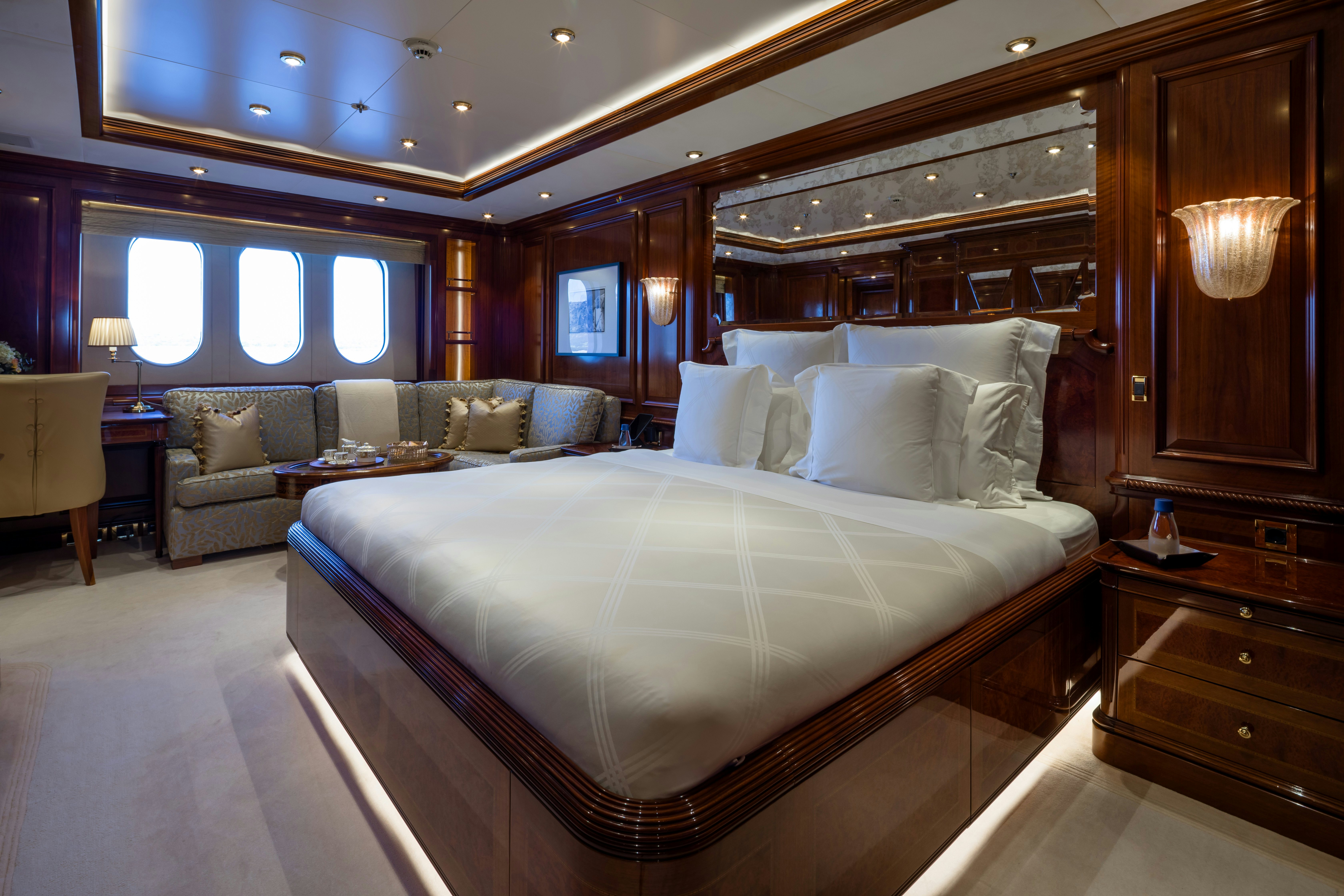 a large bed in a room aboard STARFIRE Yacht for Charter