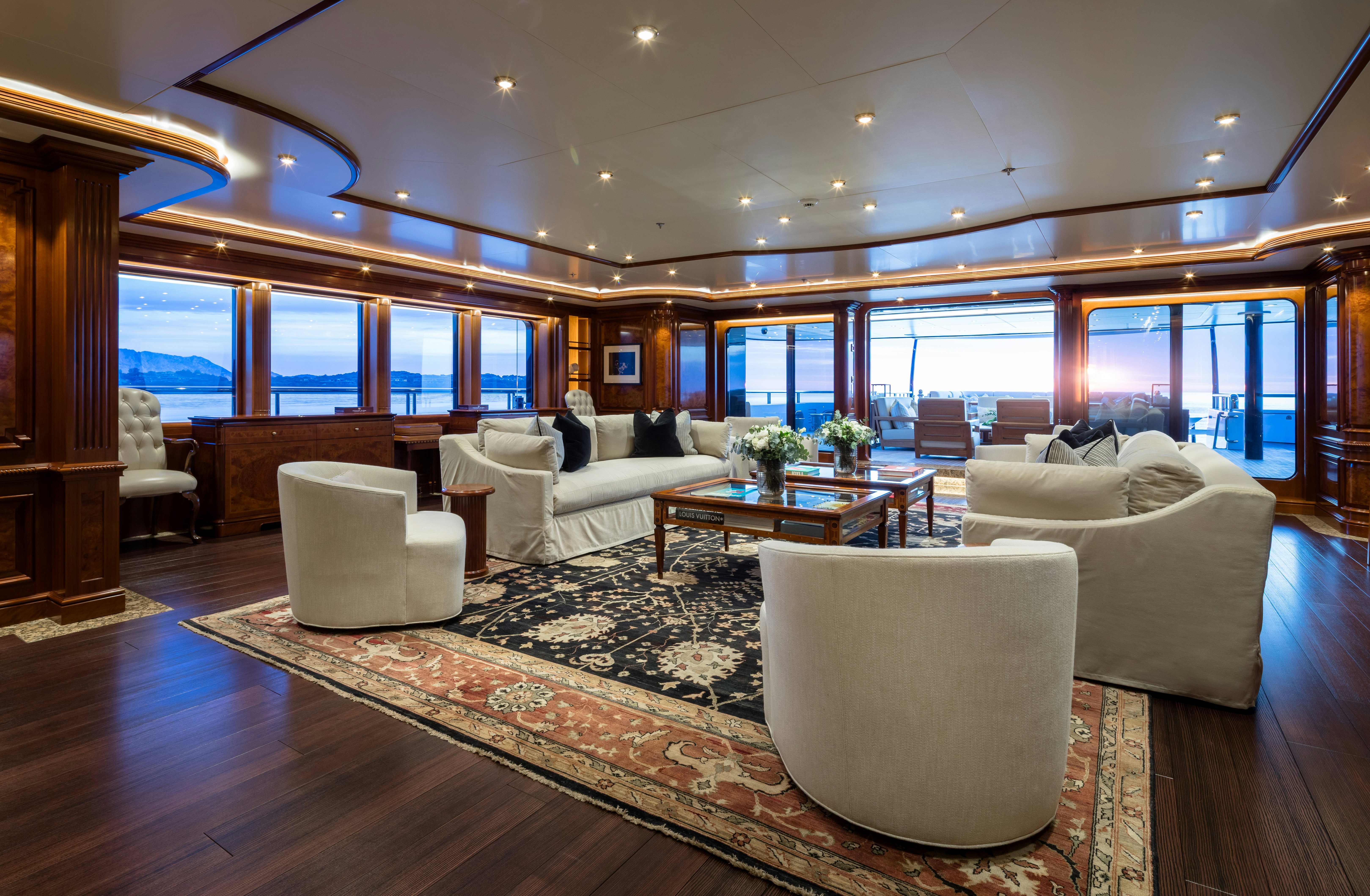 a living room with a large window aboard STARFIRE Yacht for Charter