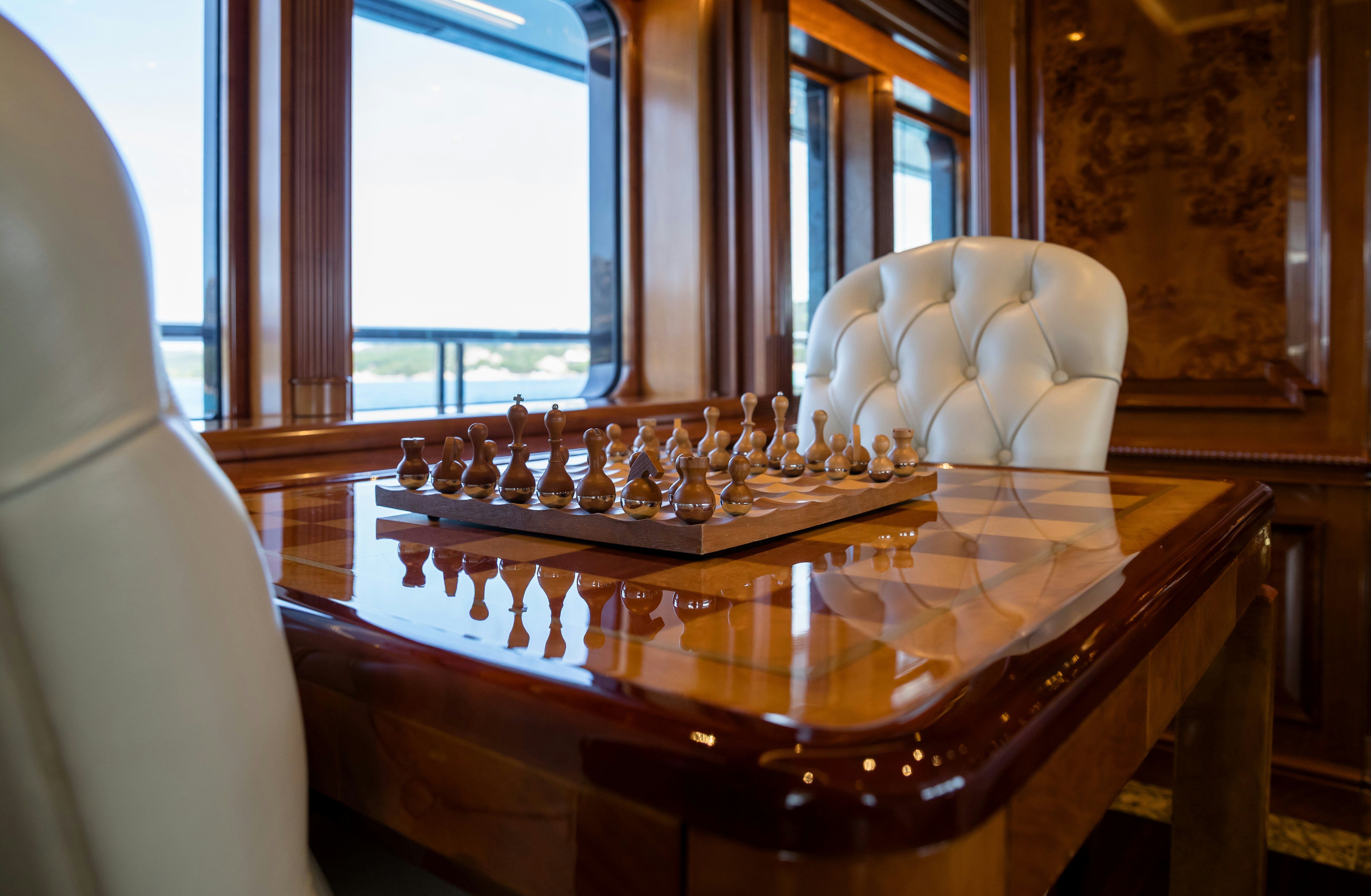 a chessboard with a white statue on it aboard STARFIRE Yacht for Charter