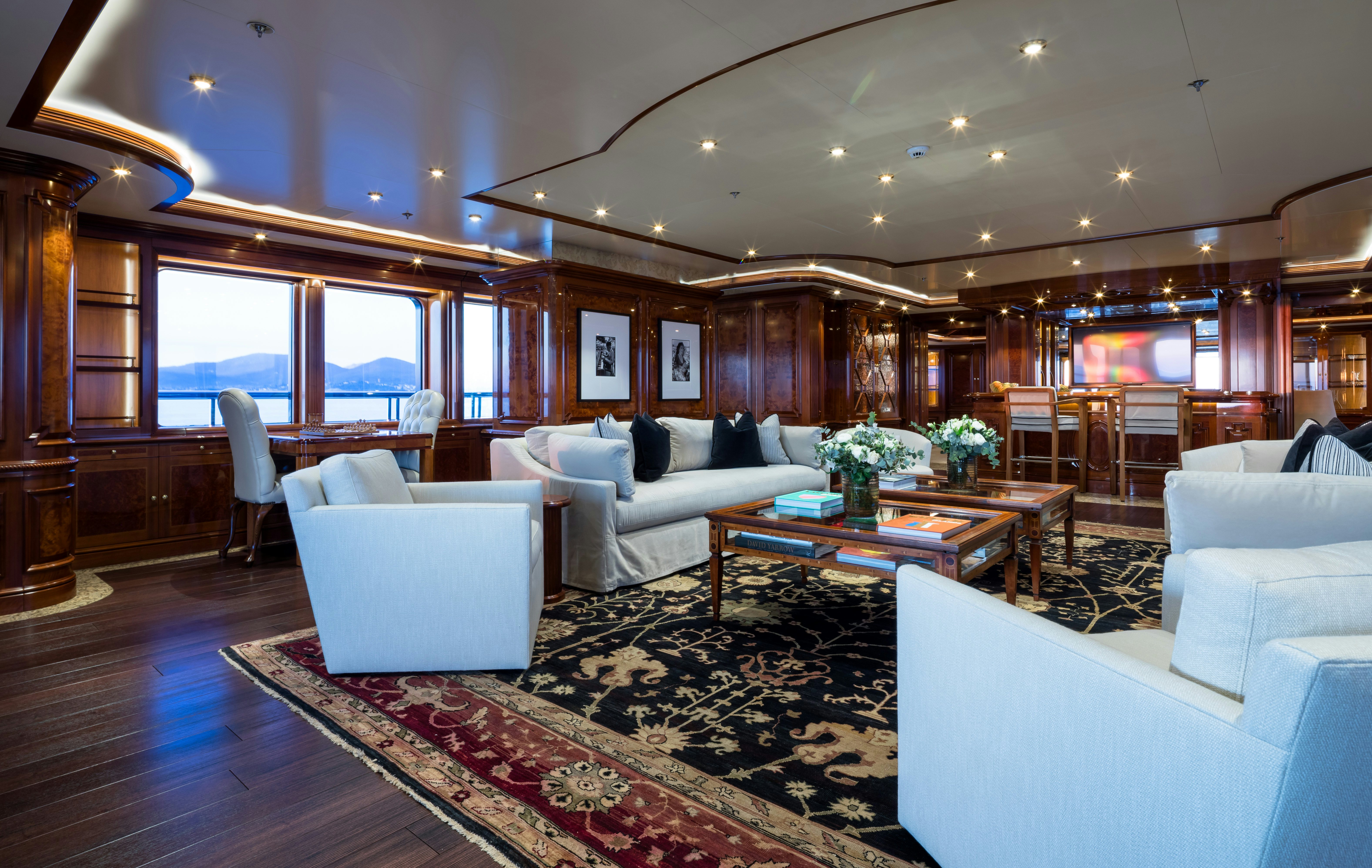 a living room with a large window aboard STARFIRE Yacht for Charter