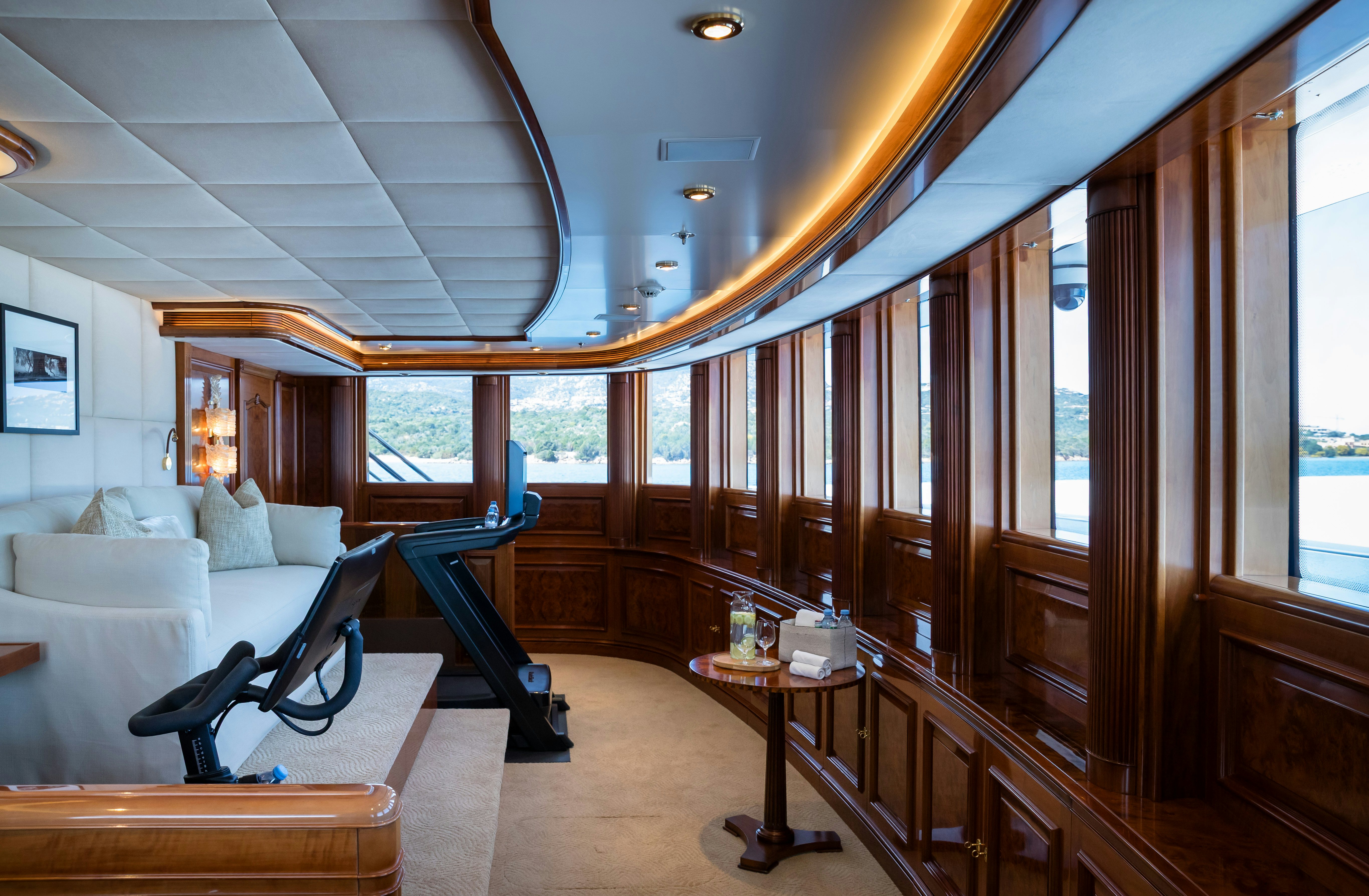 a room with a couch and a table and a window aboard STARFIRE Yacht for Charter