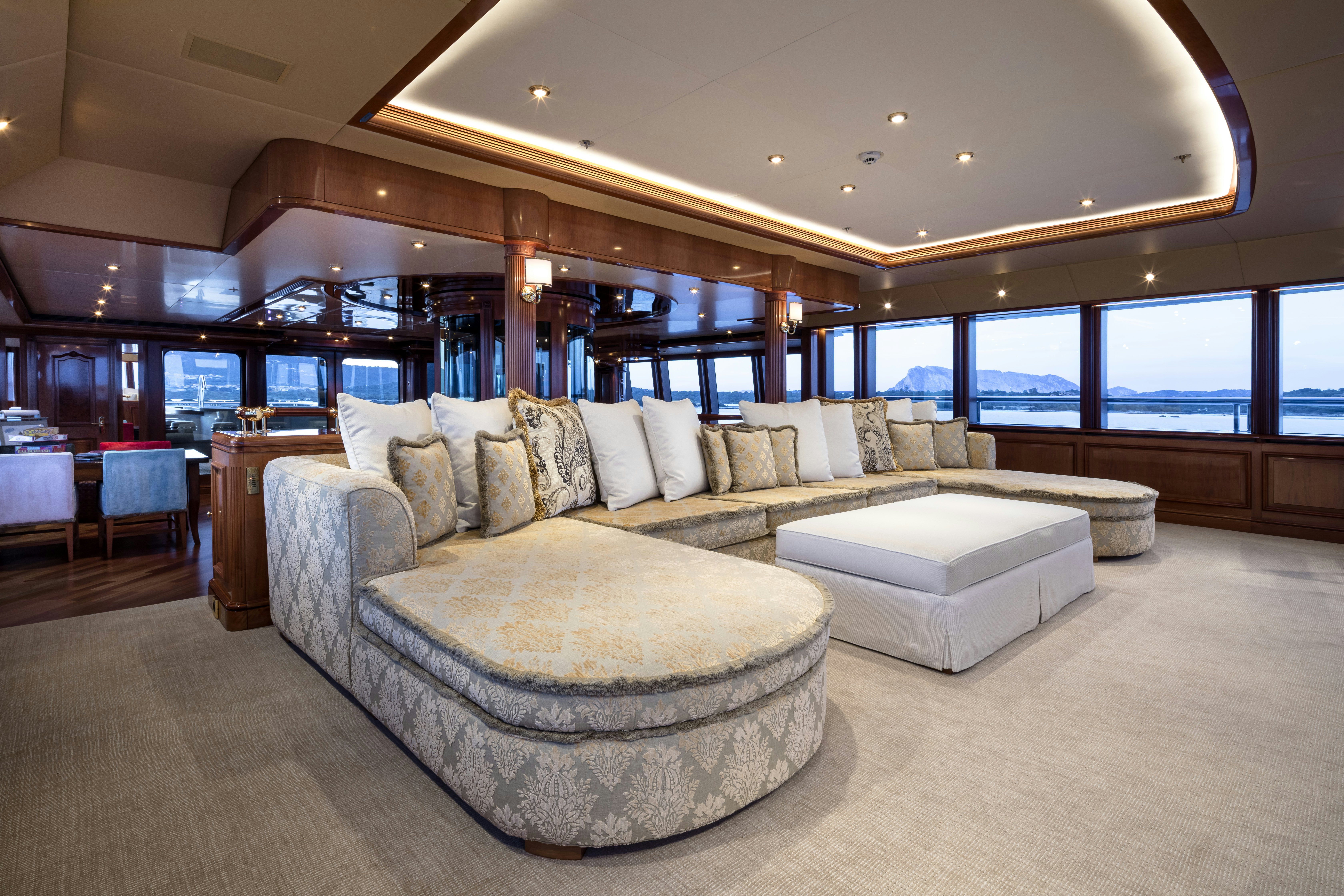 a large living room with a large window aboard STARFIRE Yacht for Charter